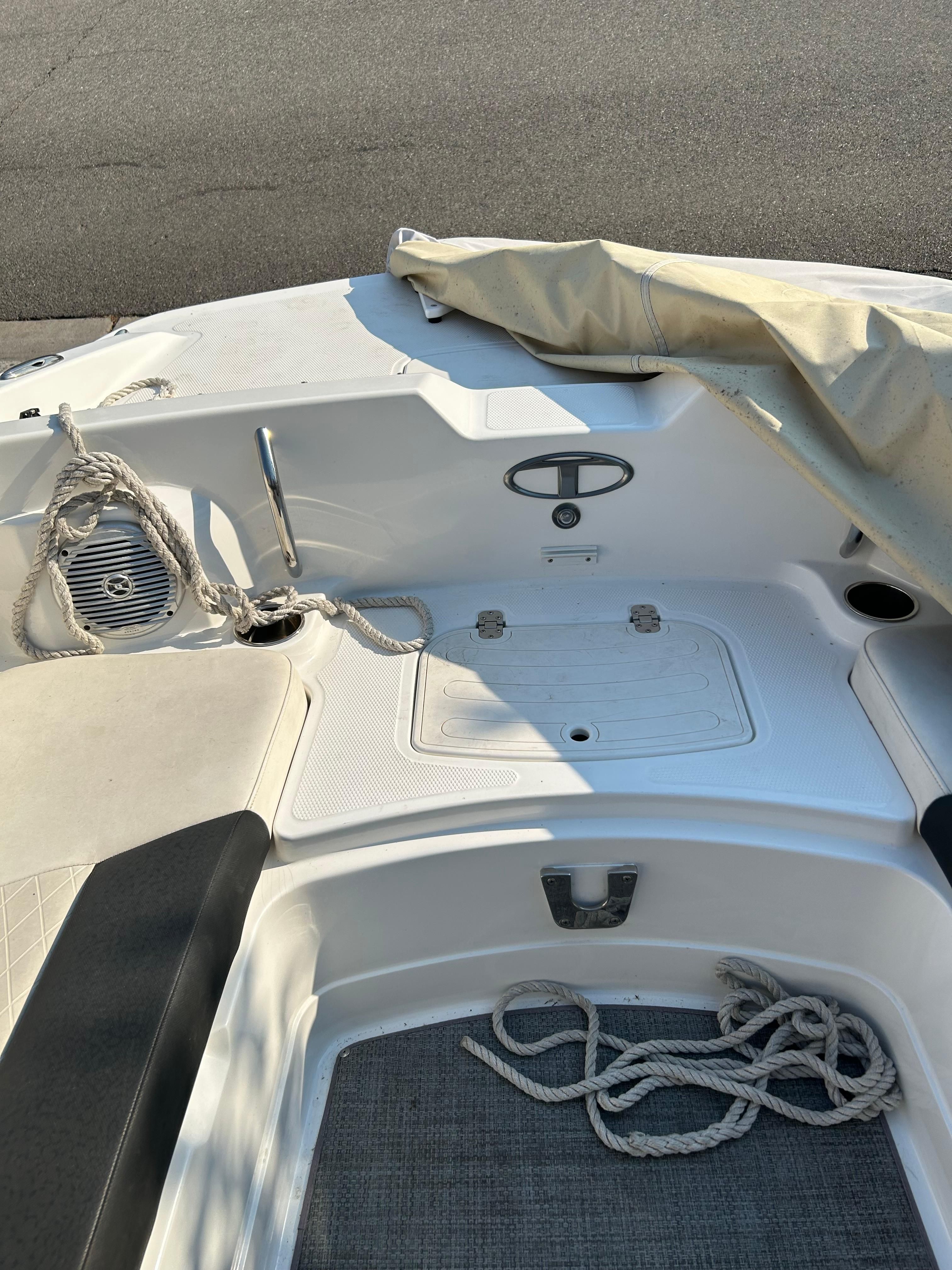 The image shows the deck of a 2017 Tracker TAHOE 2150 boat with ropes and a cover.