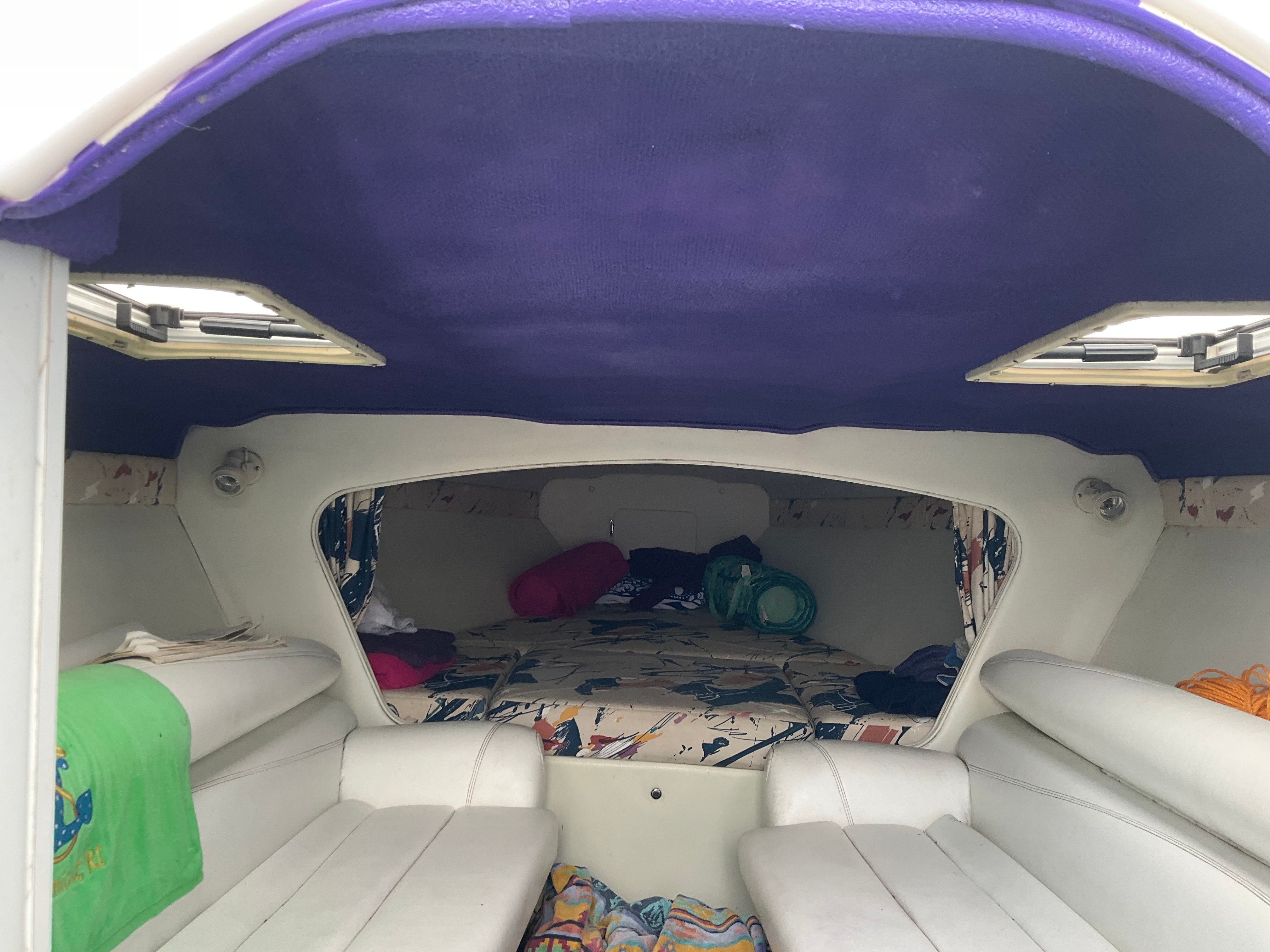 Interior of a 1995 Baja Caliber with purple ceiling and white seating.