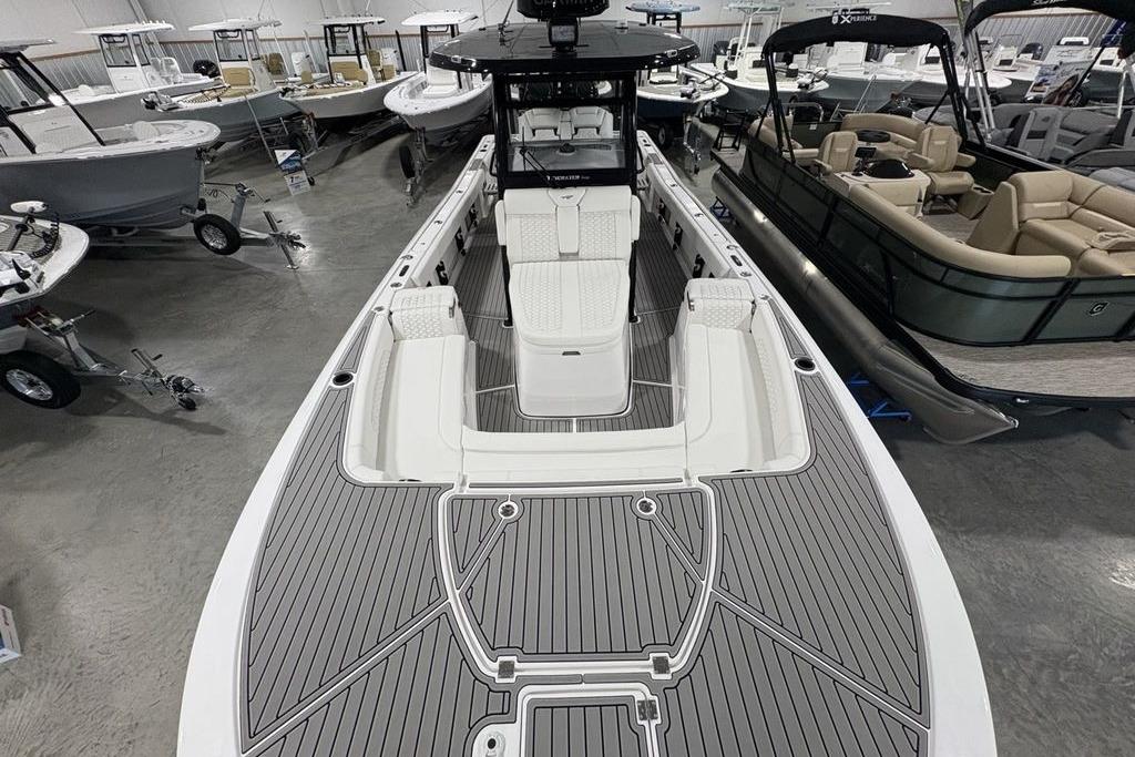2026 Tidewater 3100 Carolina Bay boat in showroom, featuring sleek design and spacious seating.