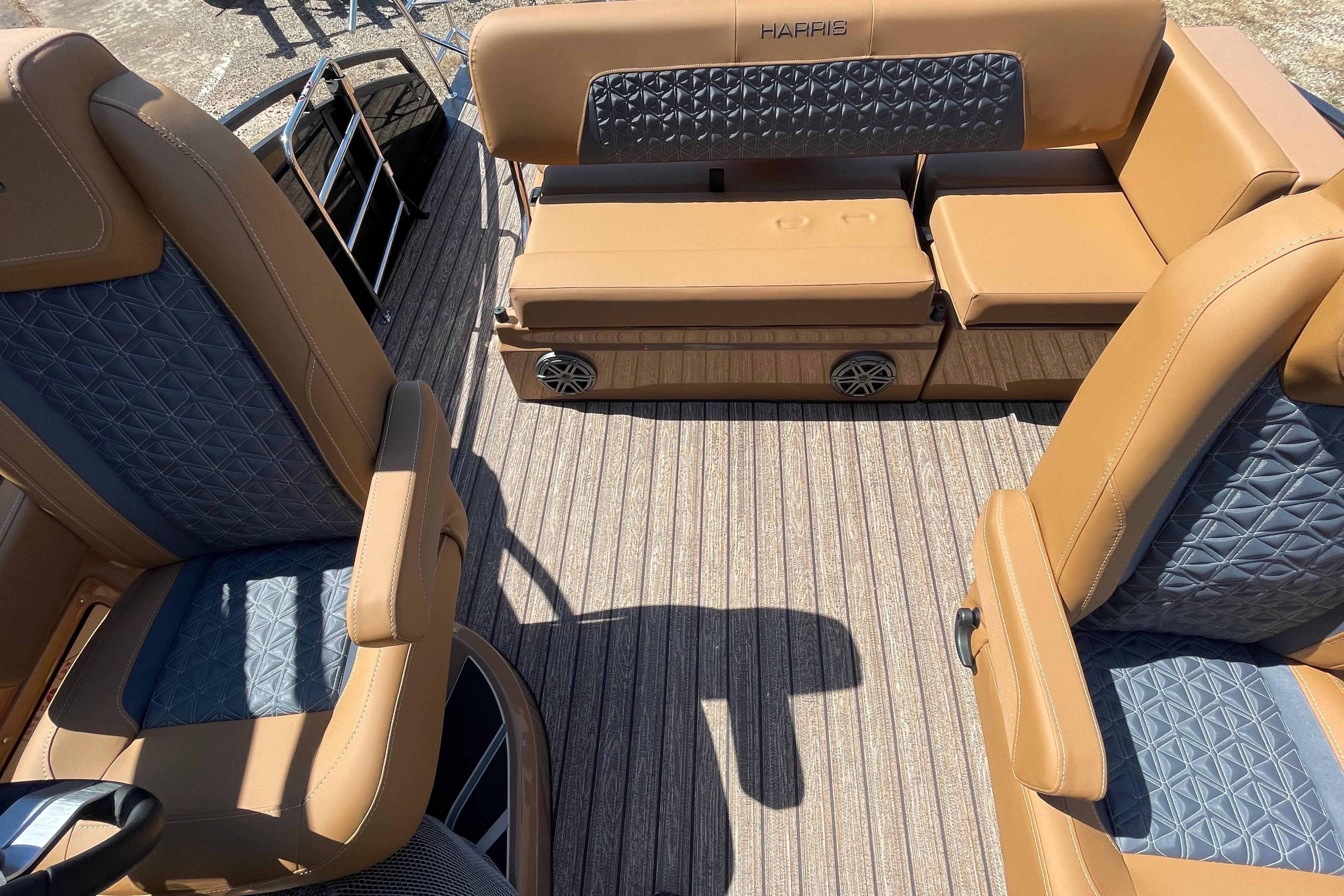 2026 Harris Solstice 250 SLDH boat interior with tan and blue seating, textured flooring.