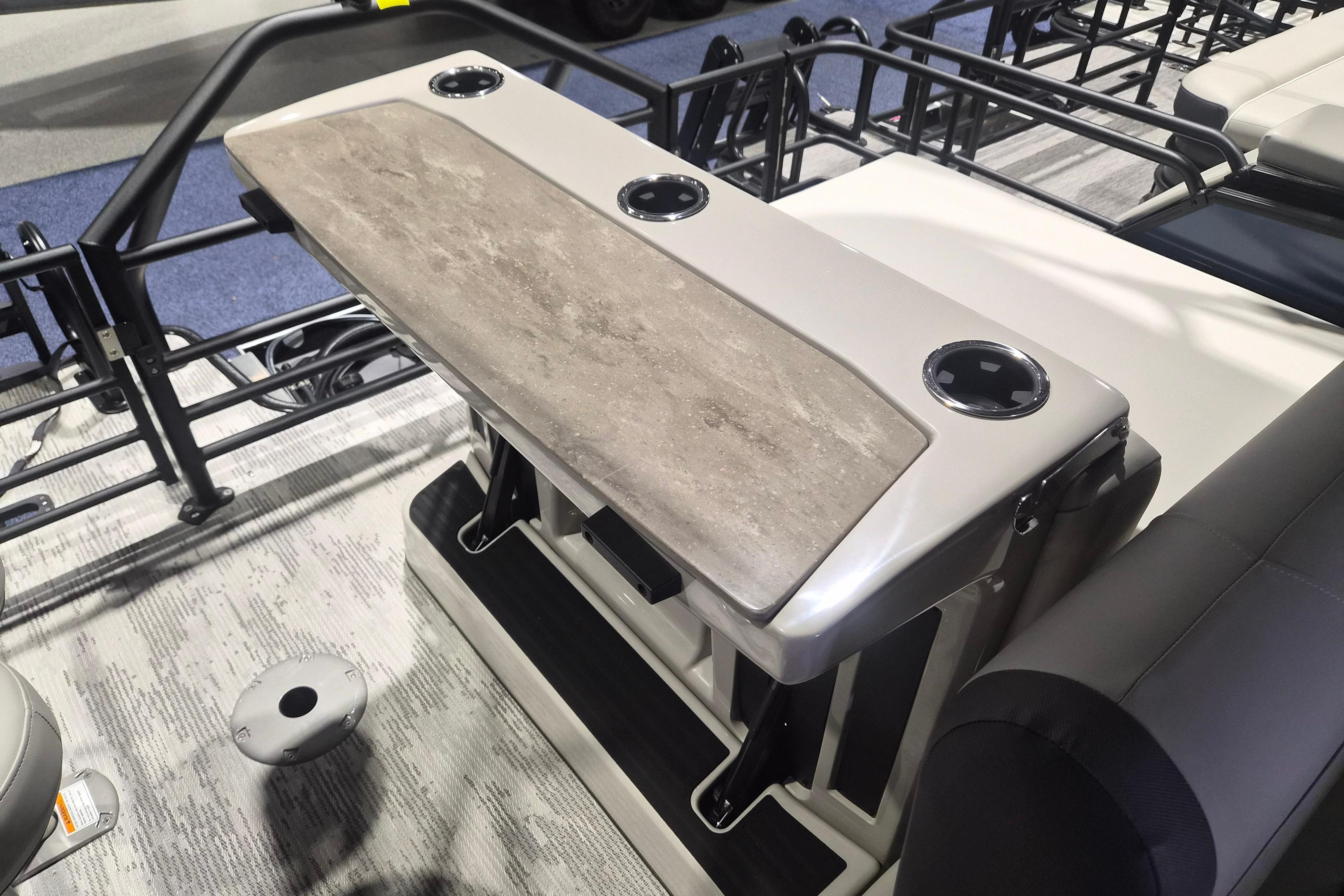 2026 Sylvan R-22 LZ DH boat interior with table and cup holders.