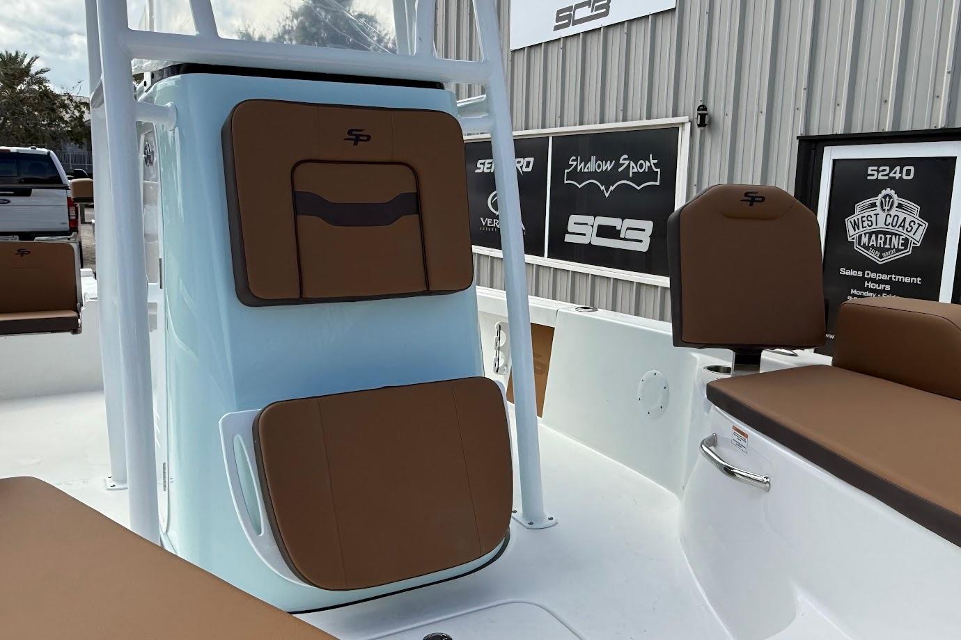 2026 Sea Pro 230 Bay boat interior with brown seating and storage compartments.