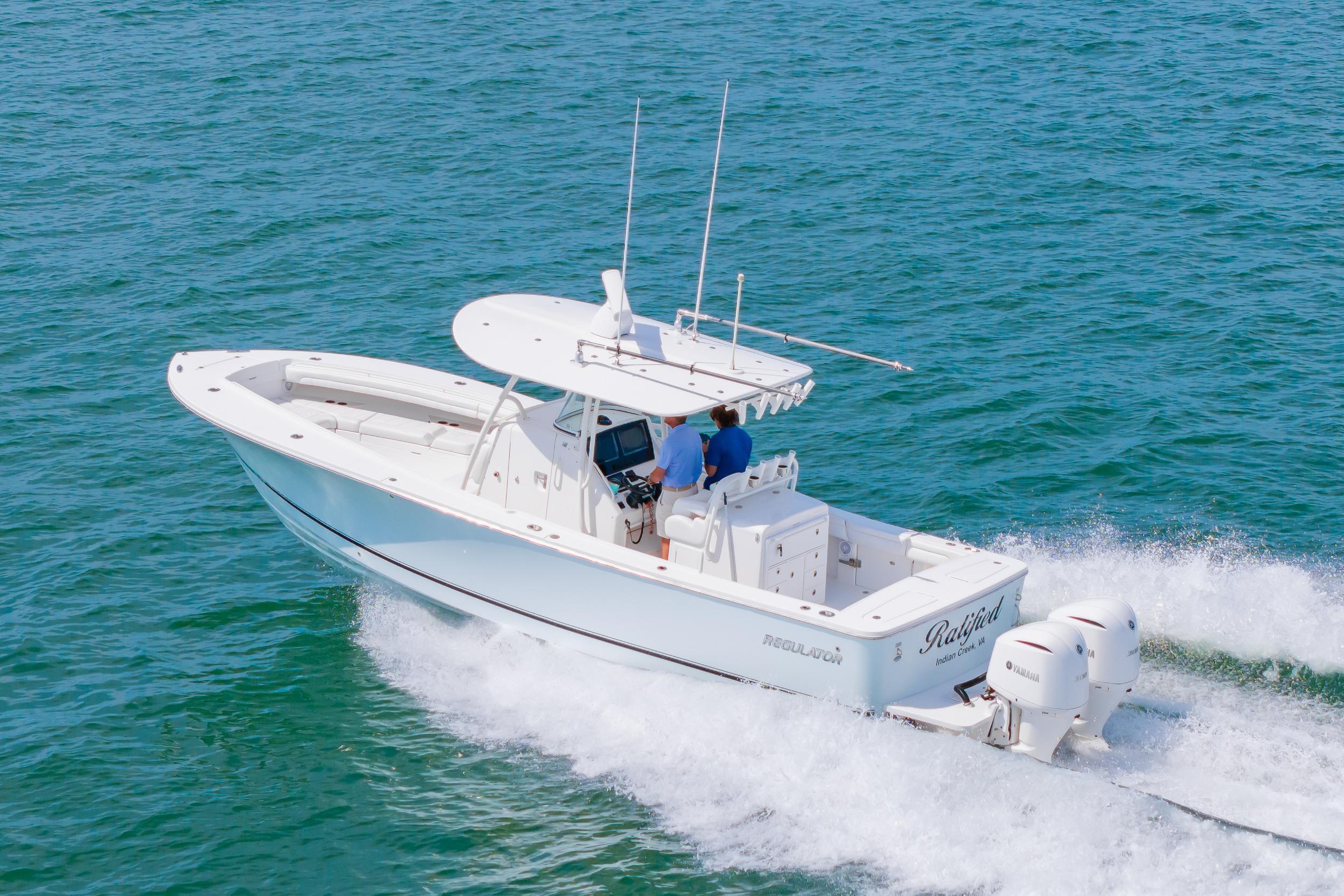 2019 Regulator 31 boat cruising on open water with twin engines.