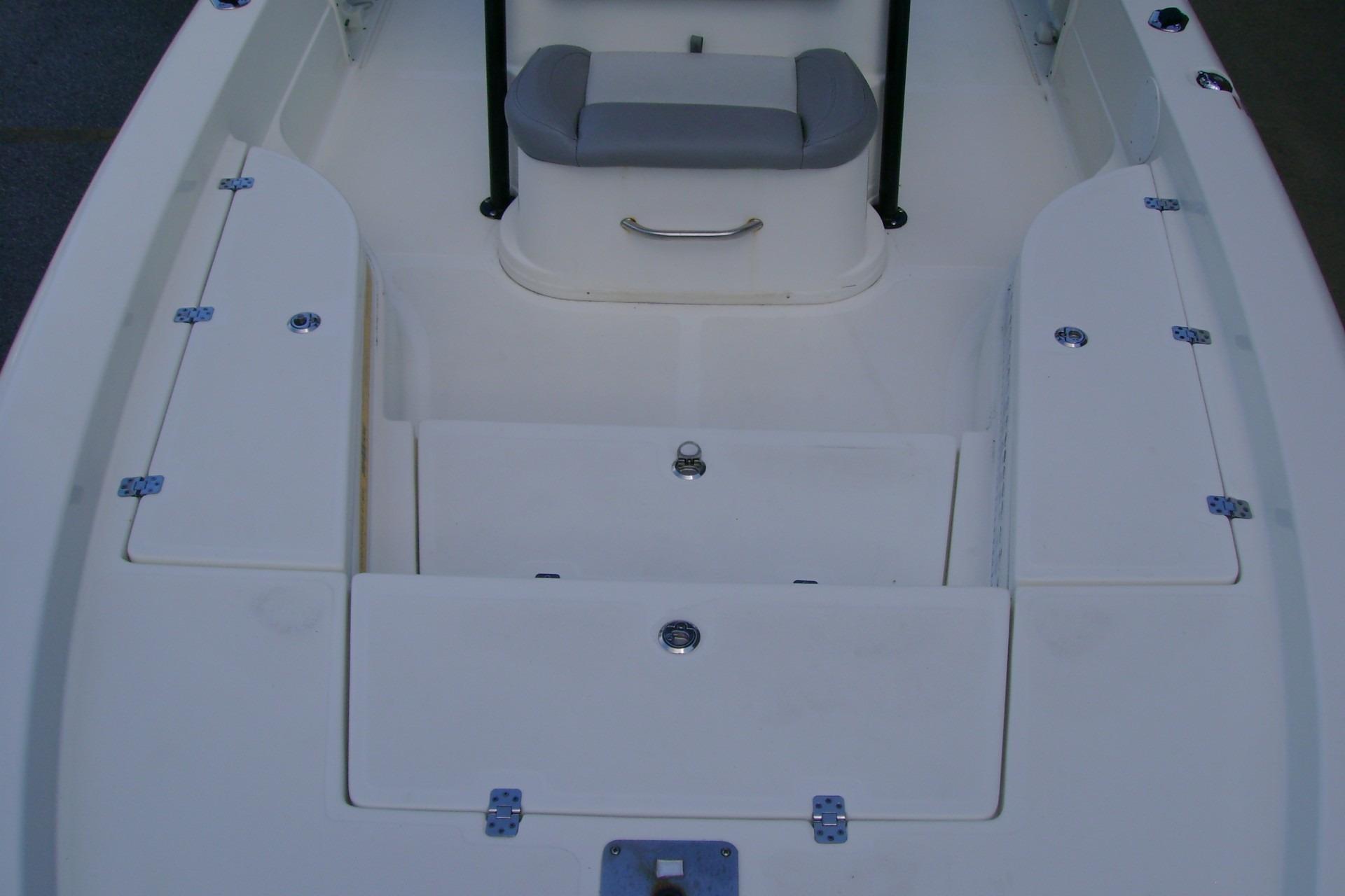 2022 NauticStar 227 XTS boat interior with storage compartments and seating.
