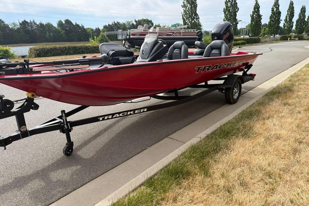 2026 Tracker Pro Team 190 boat on trailer, parked on roadside.