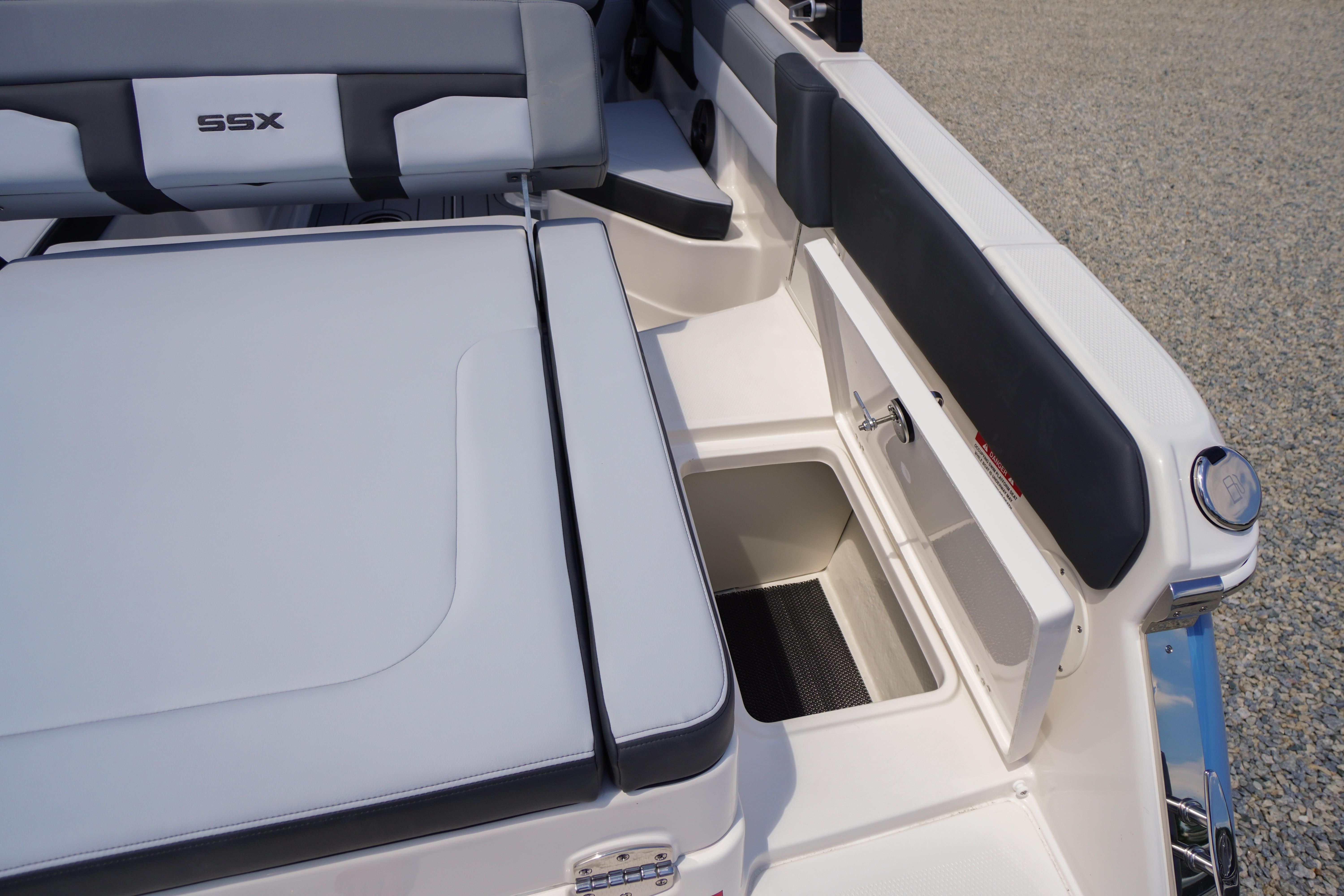 2026 Chaparral SSX 4 boat interior with cushioned seating and storage compartment.