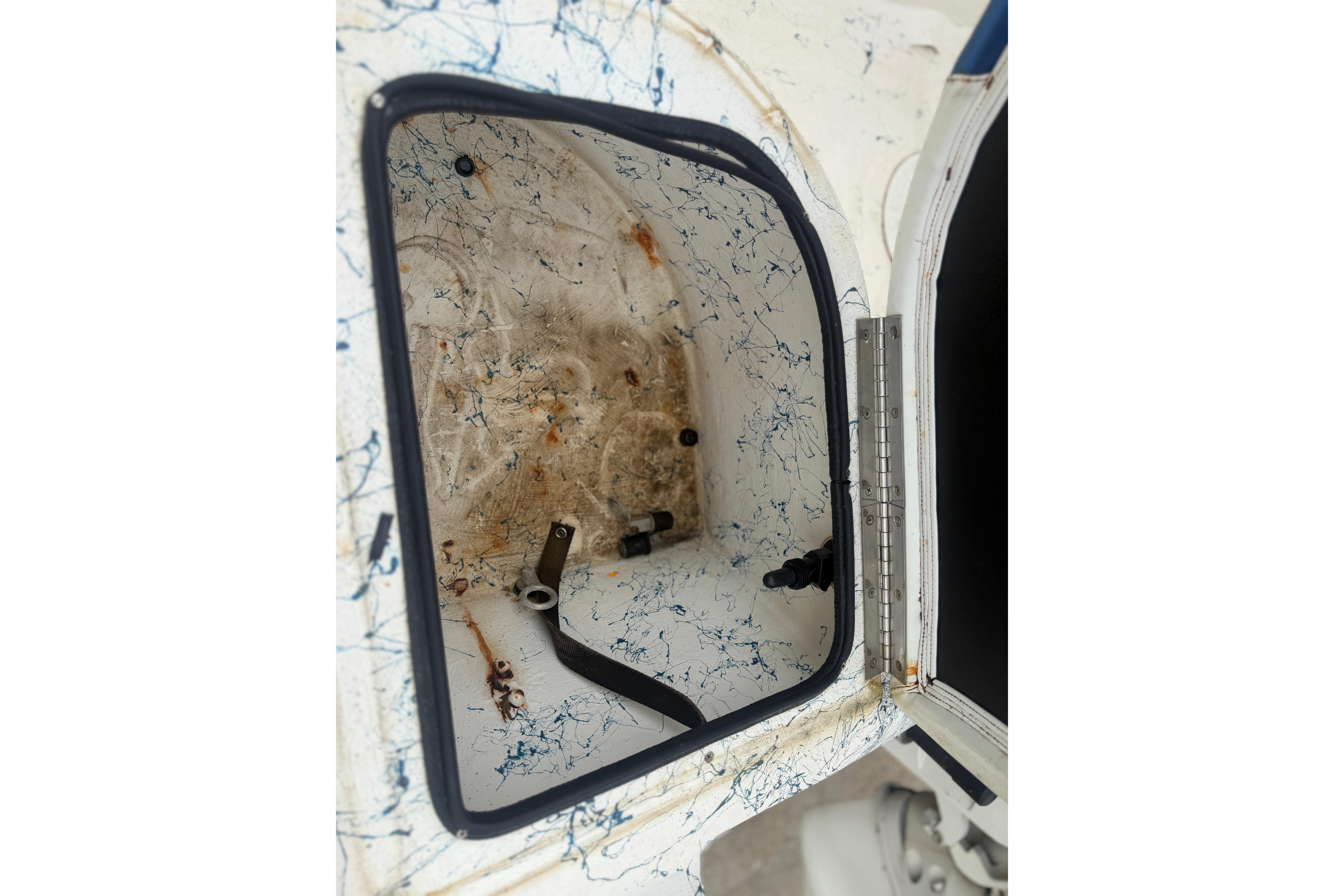 Open storage compartment of a 2004 Blue Wave 160 V-Bay boat, showing interior details.