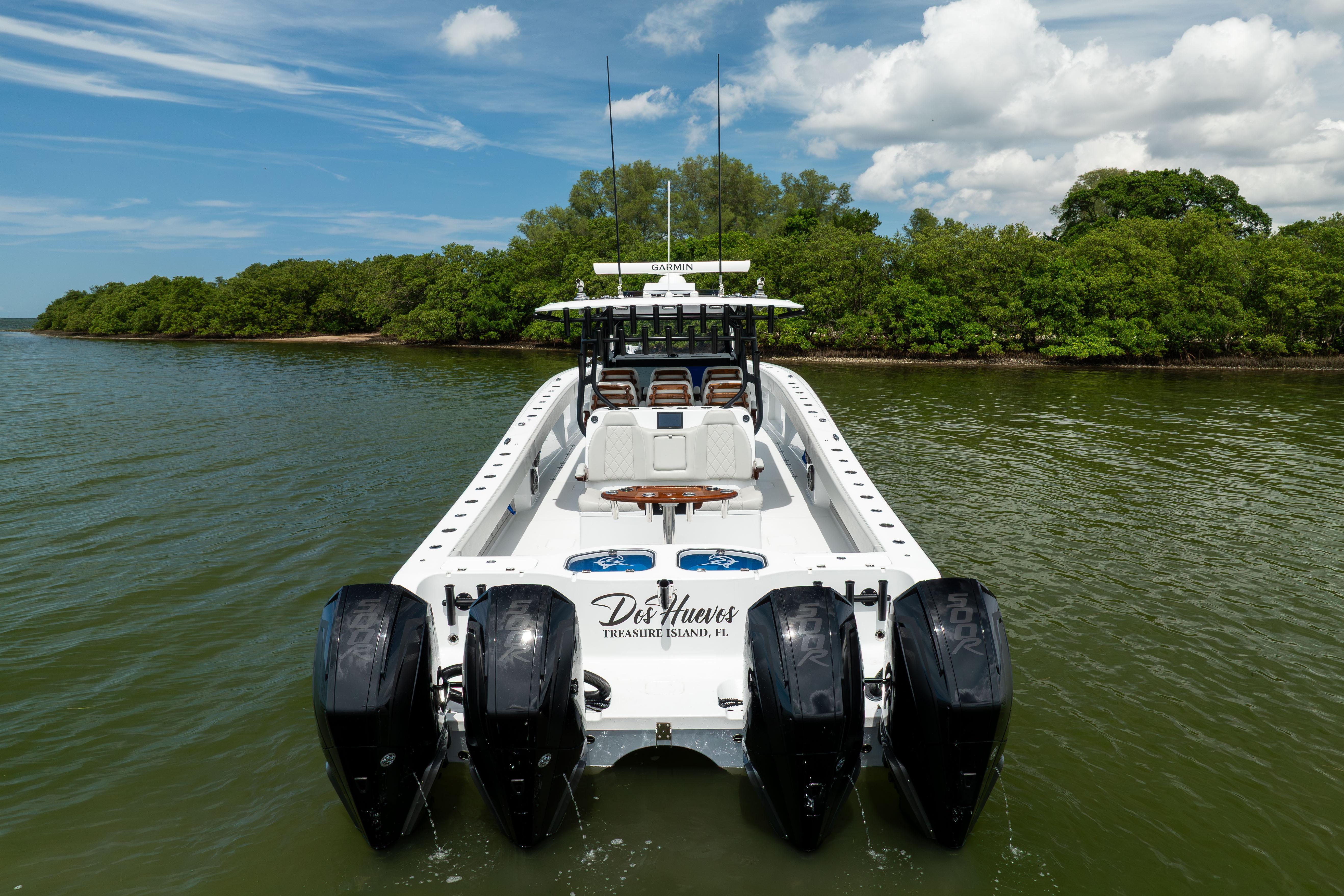 2025 Freeman 42 LR boat with four engines on a scenic waterway.