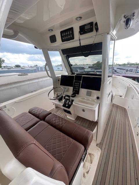 2014 Everglades 325 Center Console boat interior with brown seating and modern controls.