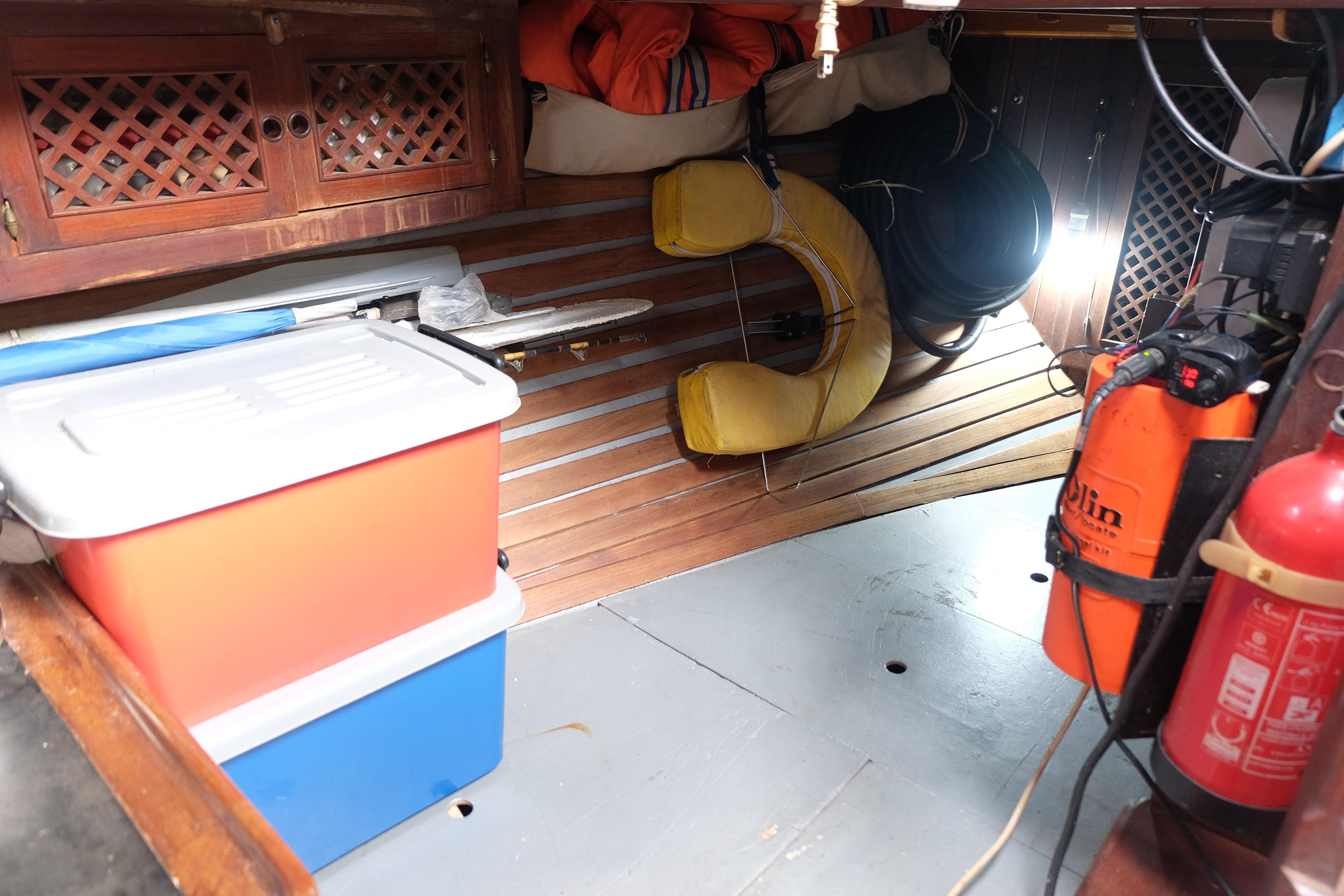 Interior of a 1979 Westwind 35 boat with storage boxes and safety equipment.