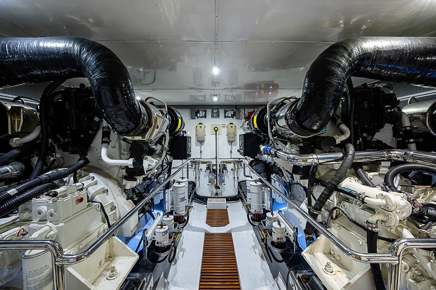 Engine room of 2014 Marlow 80 Explorer yacht, showcasing dual engines and advanced machinery.