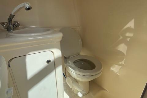 2003 Sea Ray 260 Sundancer bathroom with sink and toilet.