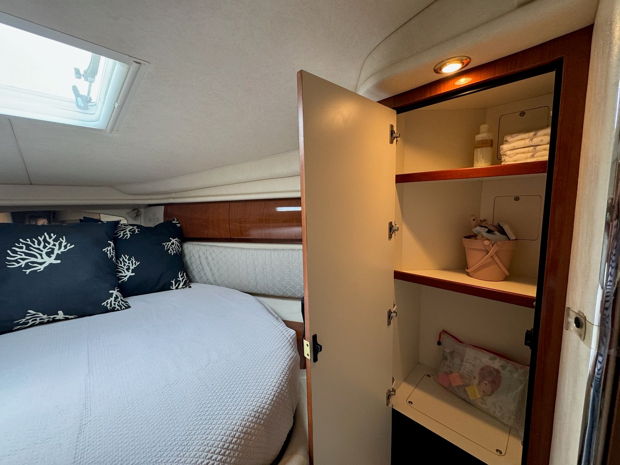 Interior of 2002 Sea Ray 360 Sundancer with bed and cabinet.