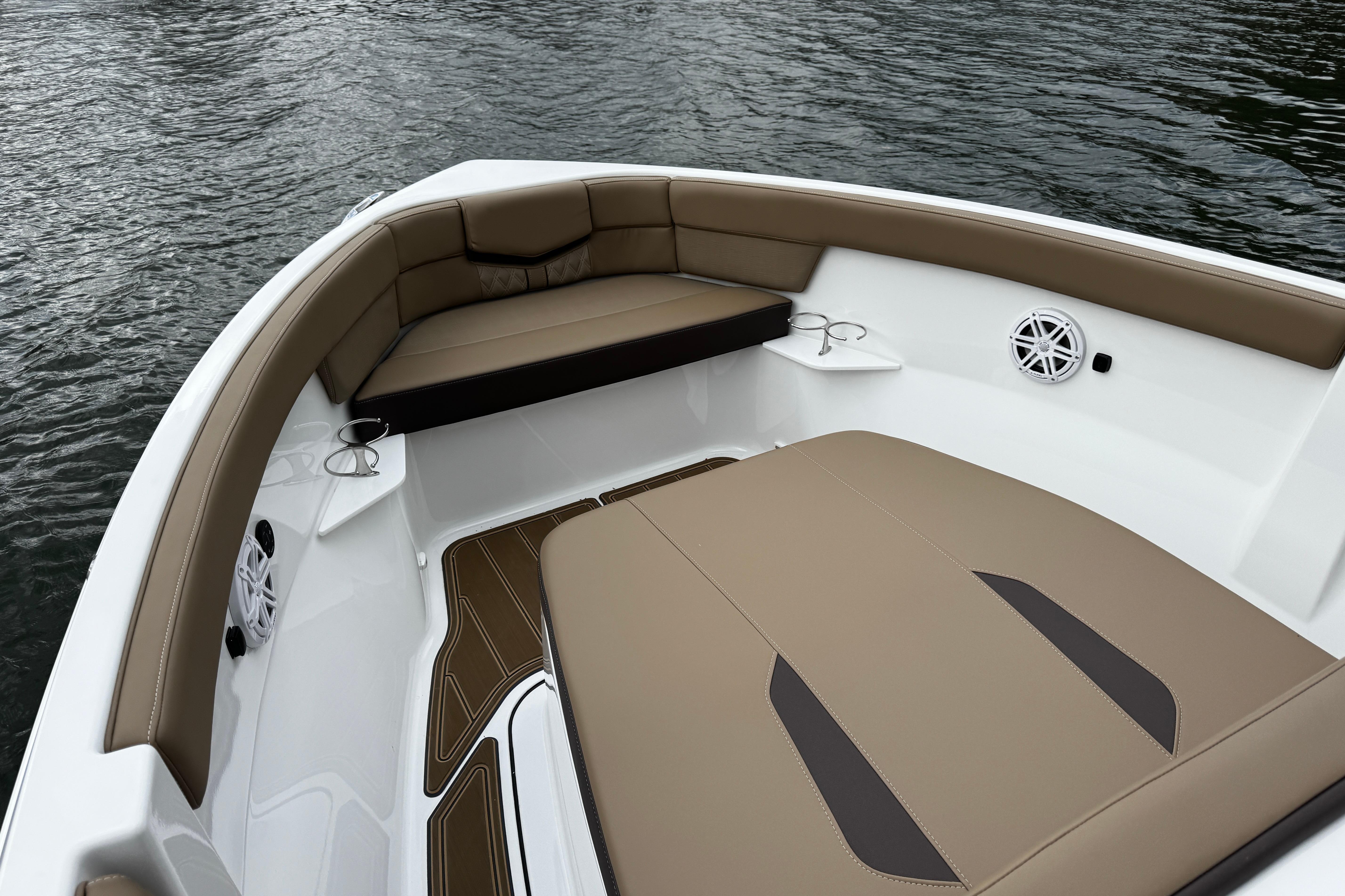 Luxurious seating on the 2026 Monterey Elite 25 OB boat, featuring elegant brown upholstery.