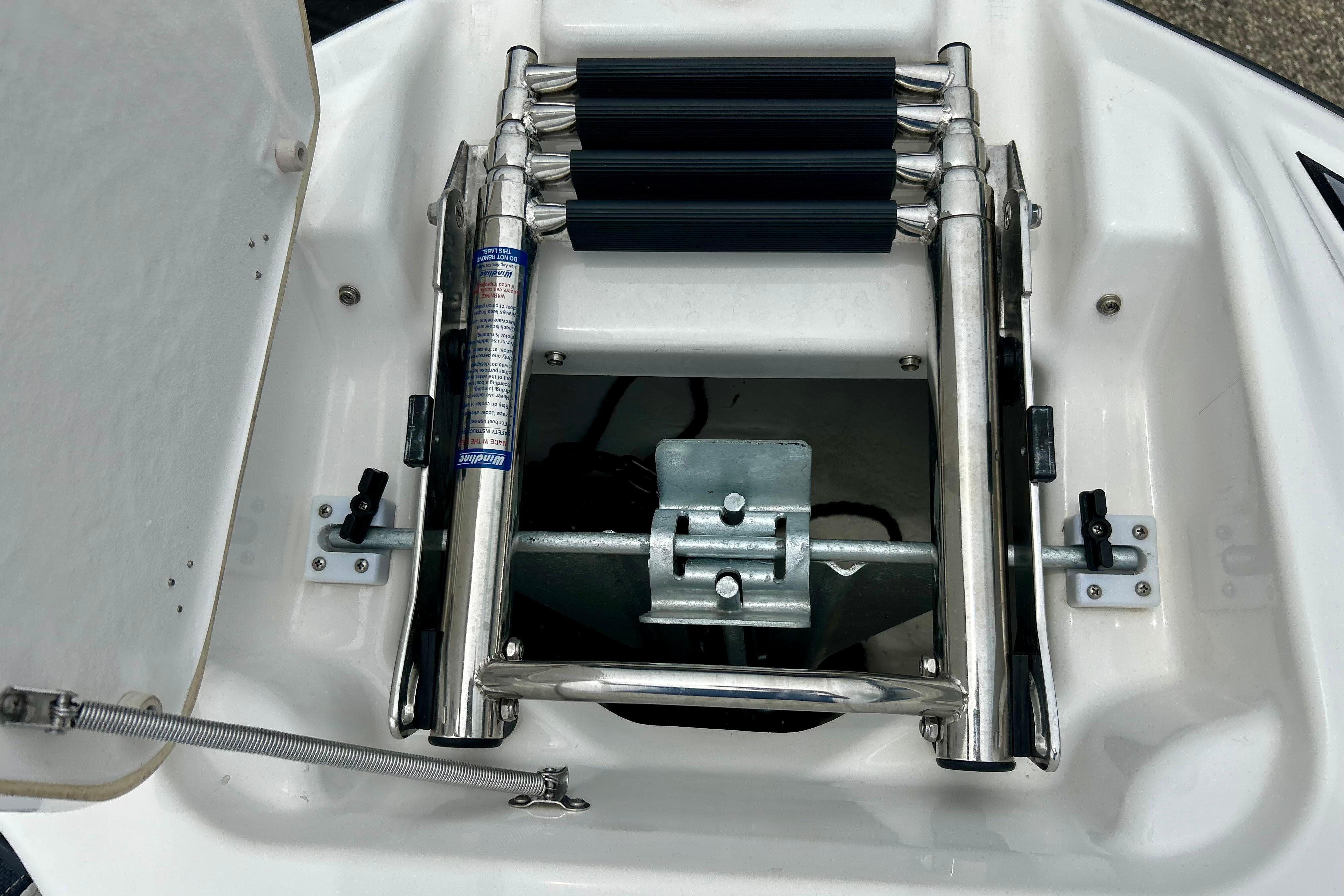 2015 Yamaha AR210 boat ladder compartment with stainless steel retractable ladder.