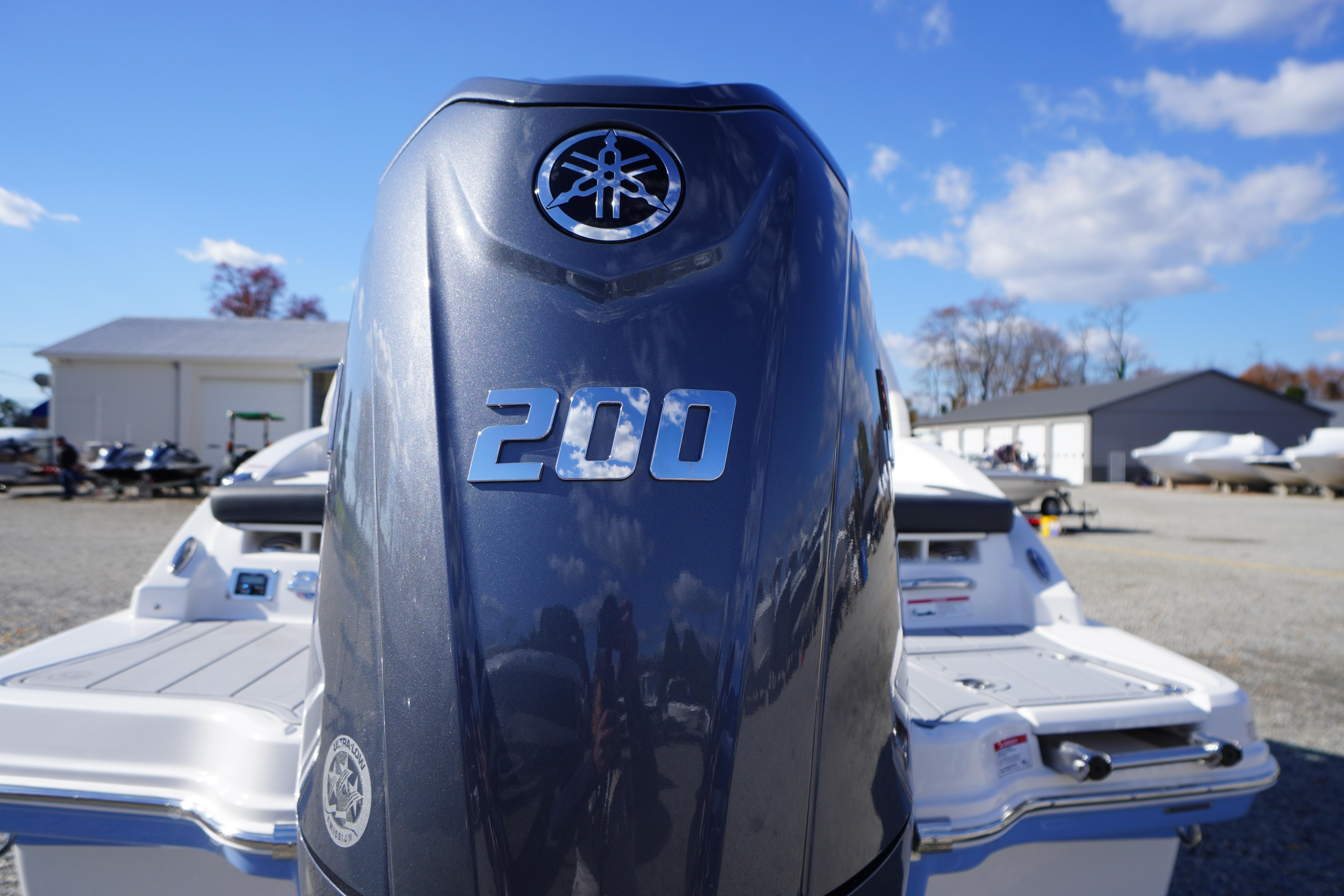 2026 Chaparral 23 SSi OB boat with Yamaha 200 outboard engine, outdoor setting.