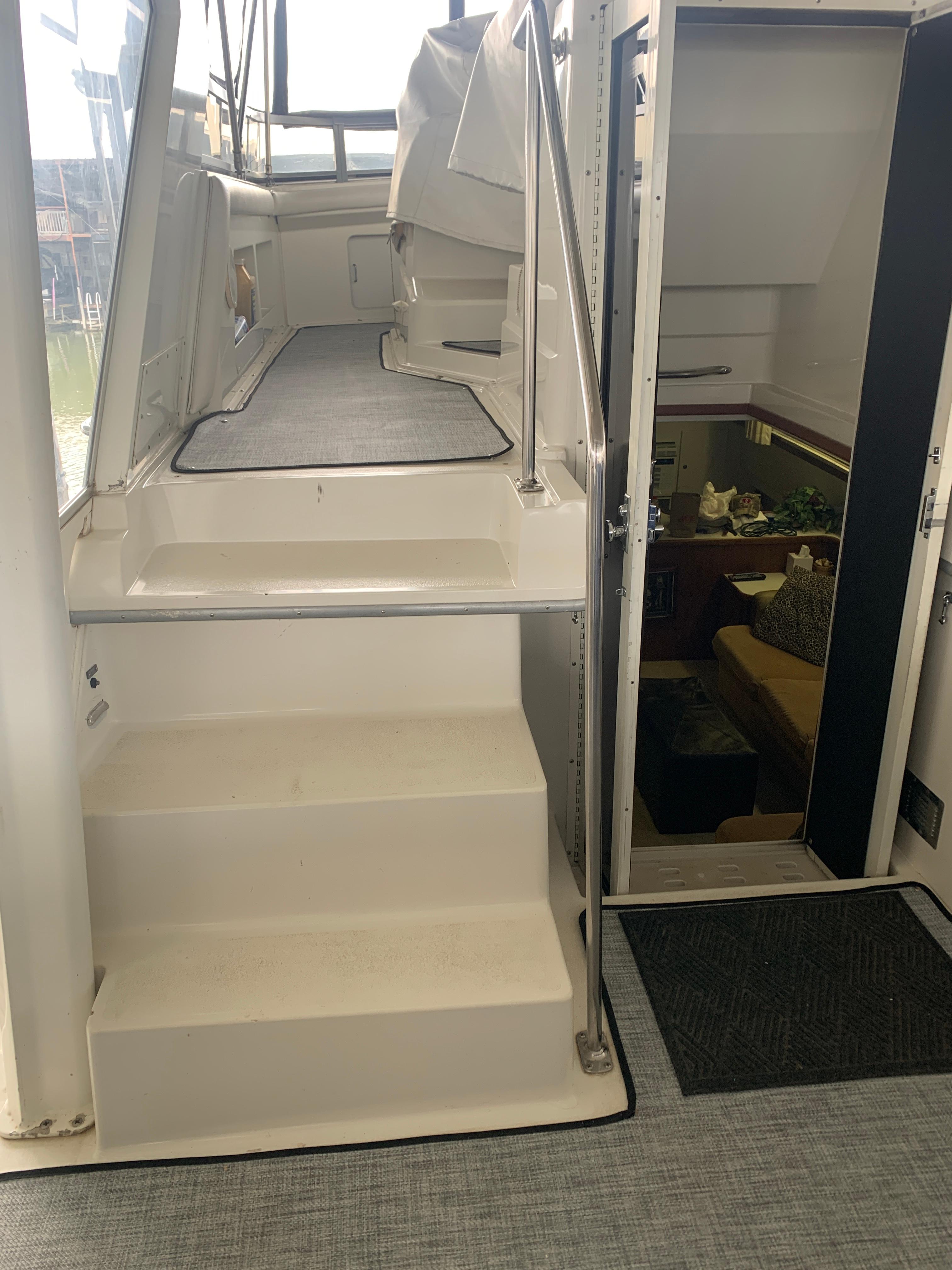 1994 Carver 440 Aft Cabin Motor Yacht interior with stairs and cabin entrance.