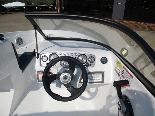 2023 Tahoe 185 S boat dashboard with steering wheel and control panel.