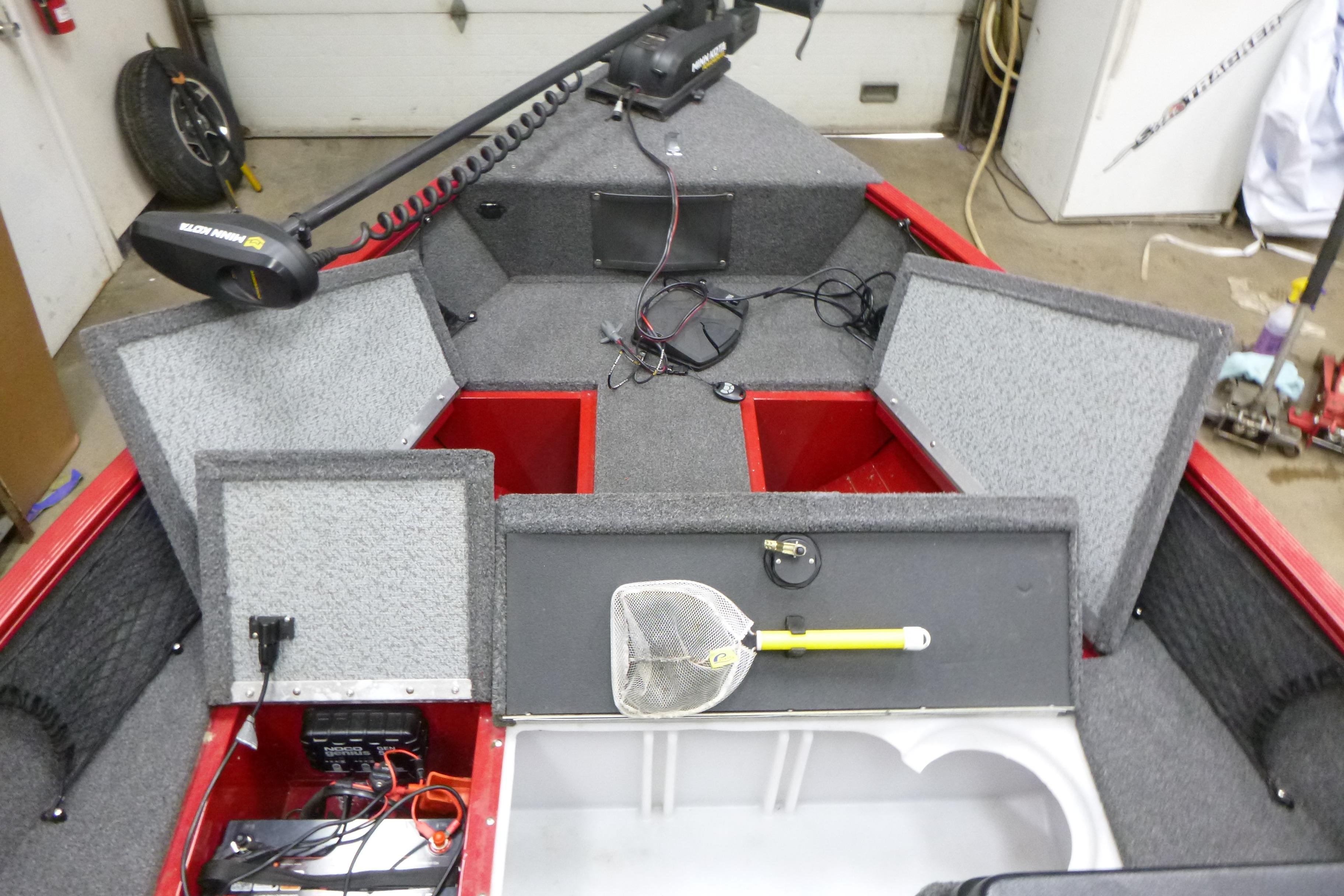 2022 Lund 1650 Angler Sport boat interior with storage compartments open.