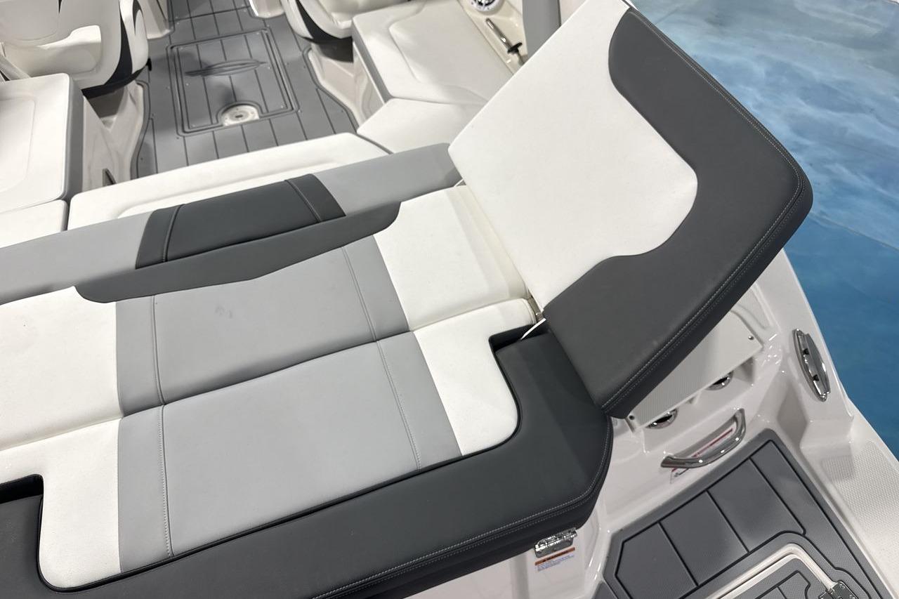 The image shows the interior of a Chaparral 23 SSi boat with modern, cushioned seating.