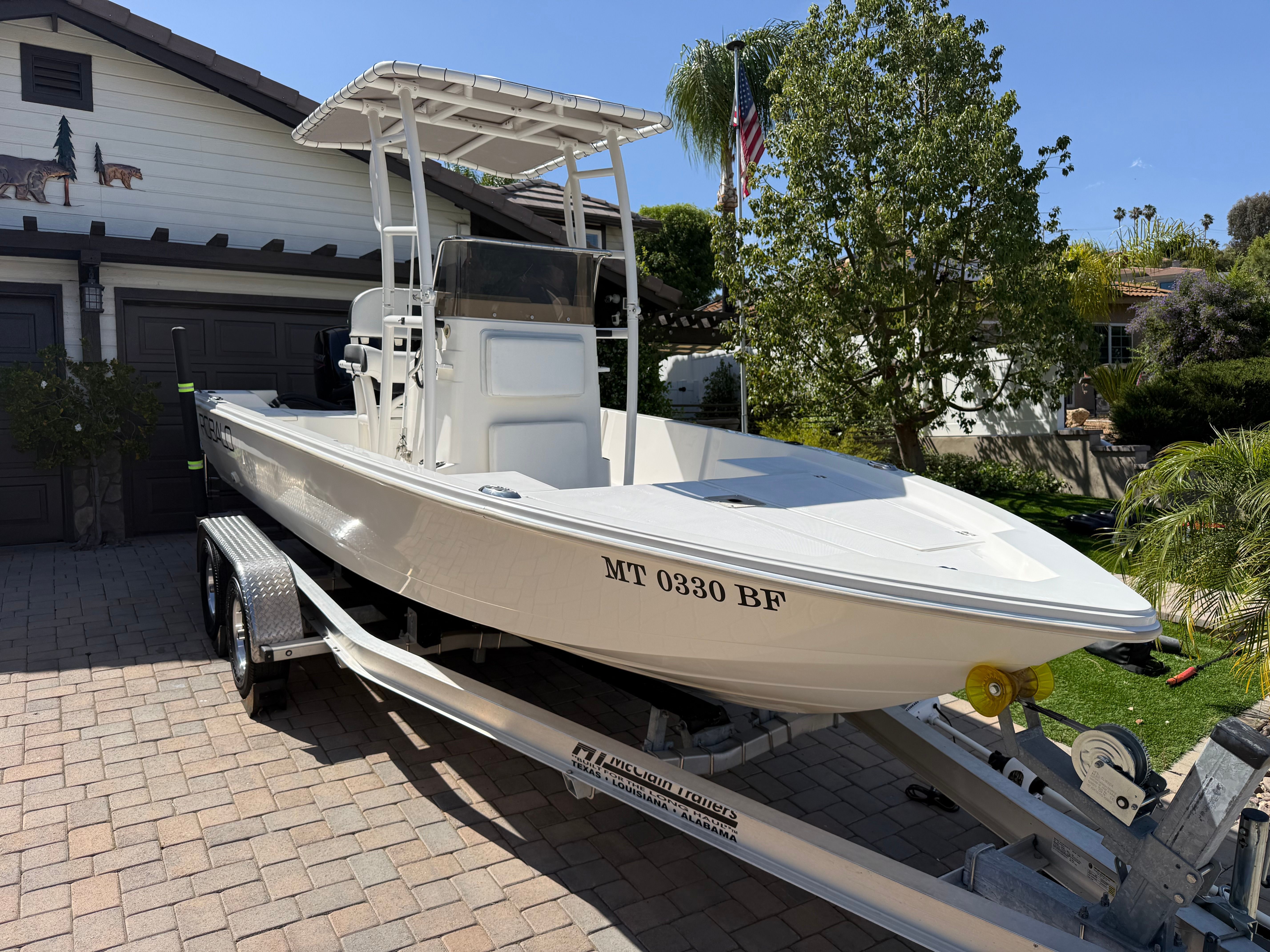 1998 Robalo 2100 Bay Hunter on trailer in front of house.