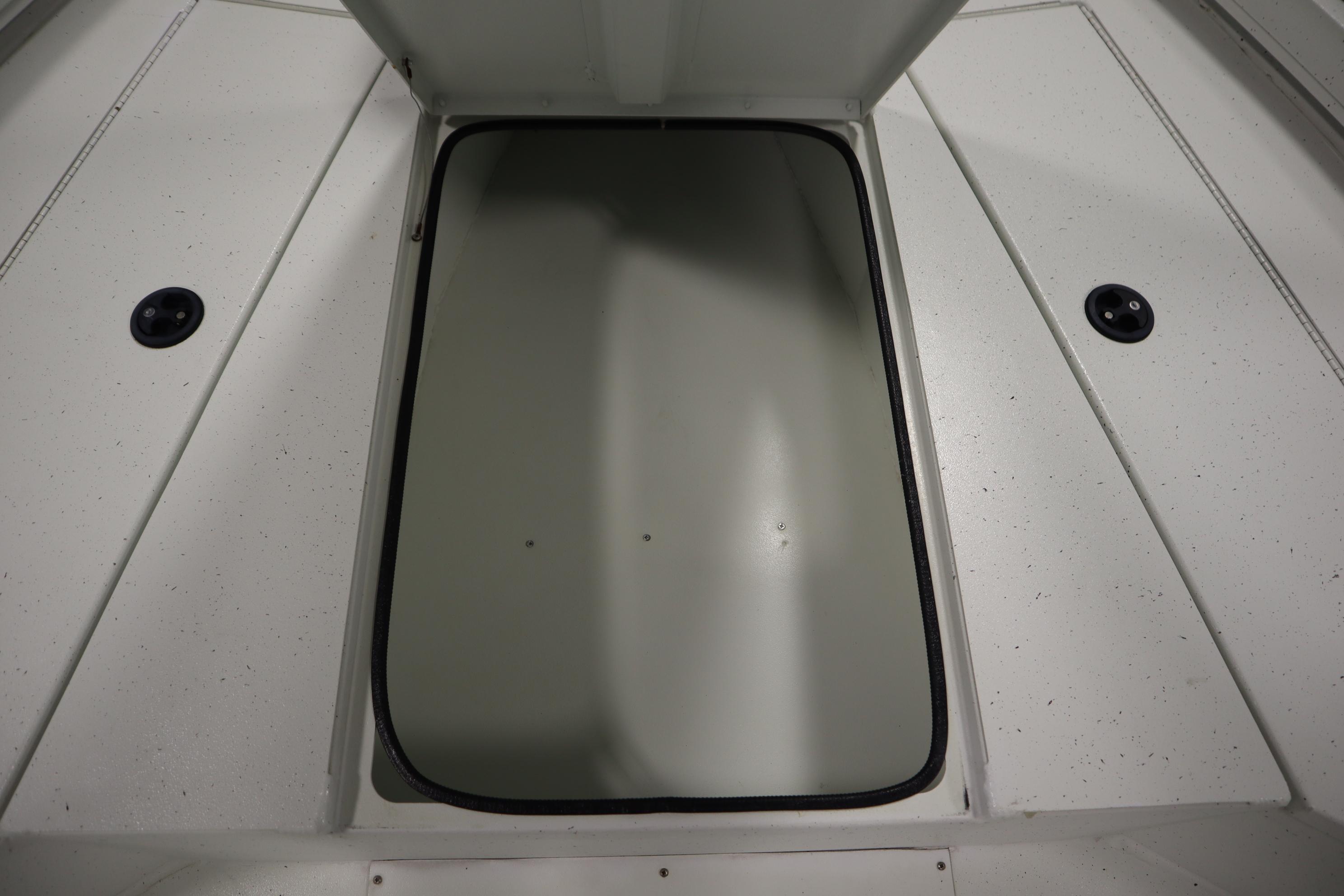 Open storage compartment on 2022 Crestliner 2200 CC boat deck.