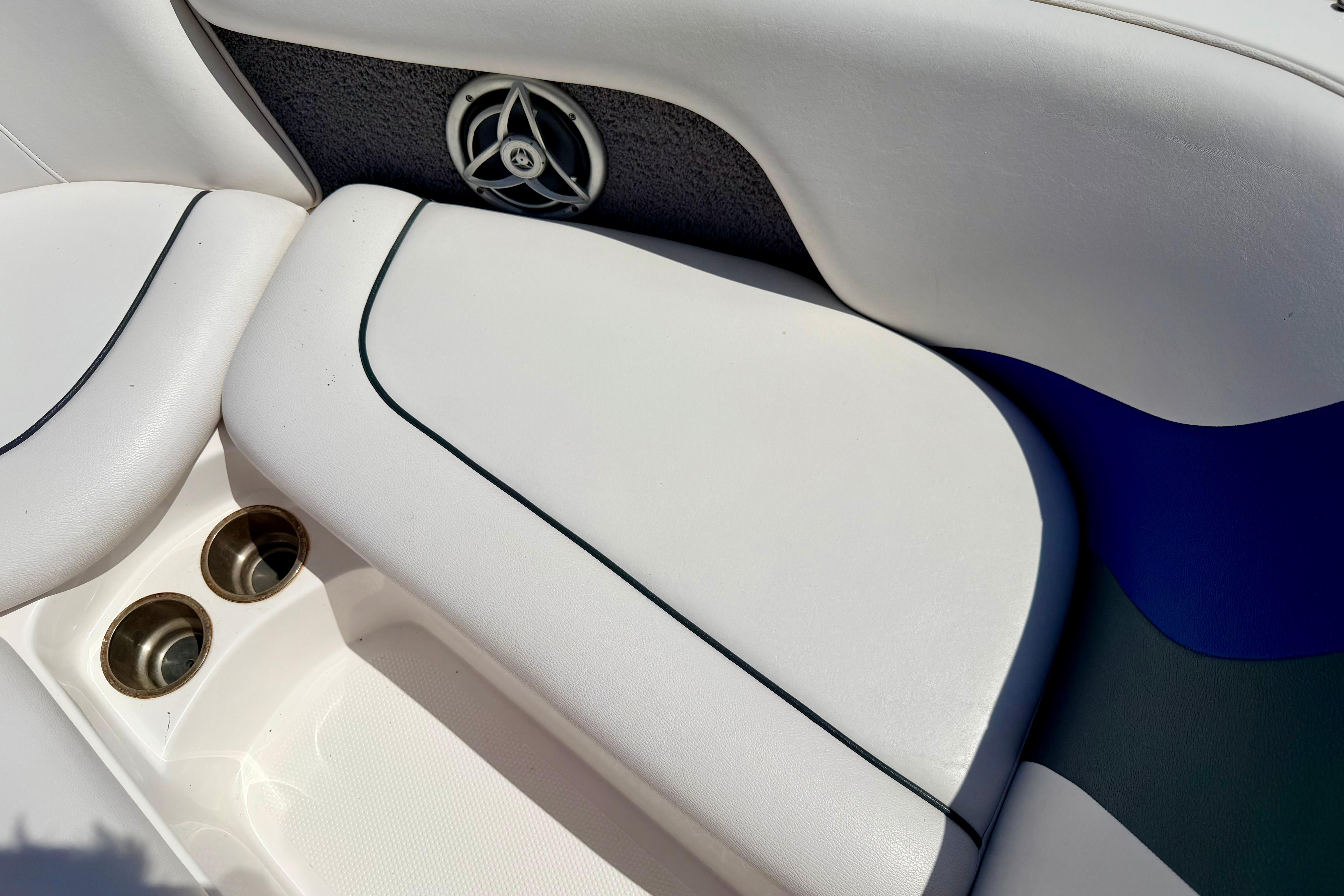 2008 Moomba Outback V boat interior with white seating and cup holders.