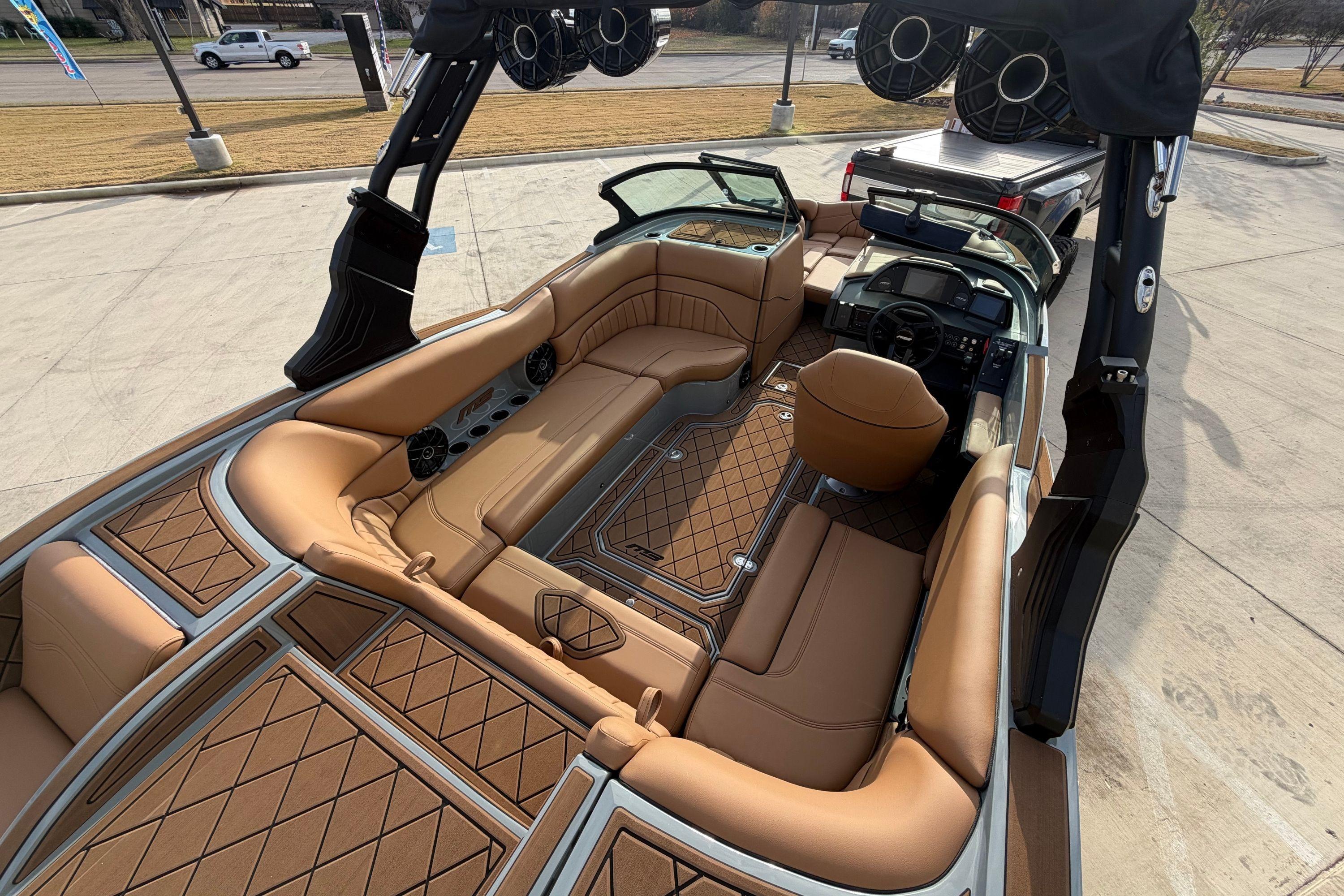 2026 MB B52 21 Alpha boat interior with tan leather seating and advanced dashboard.