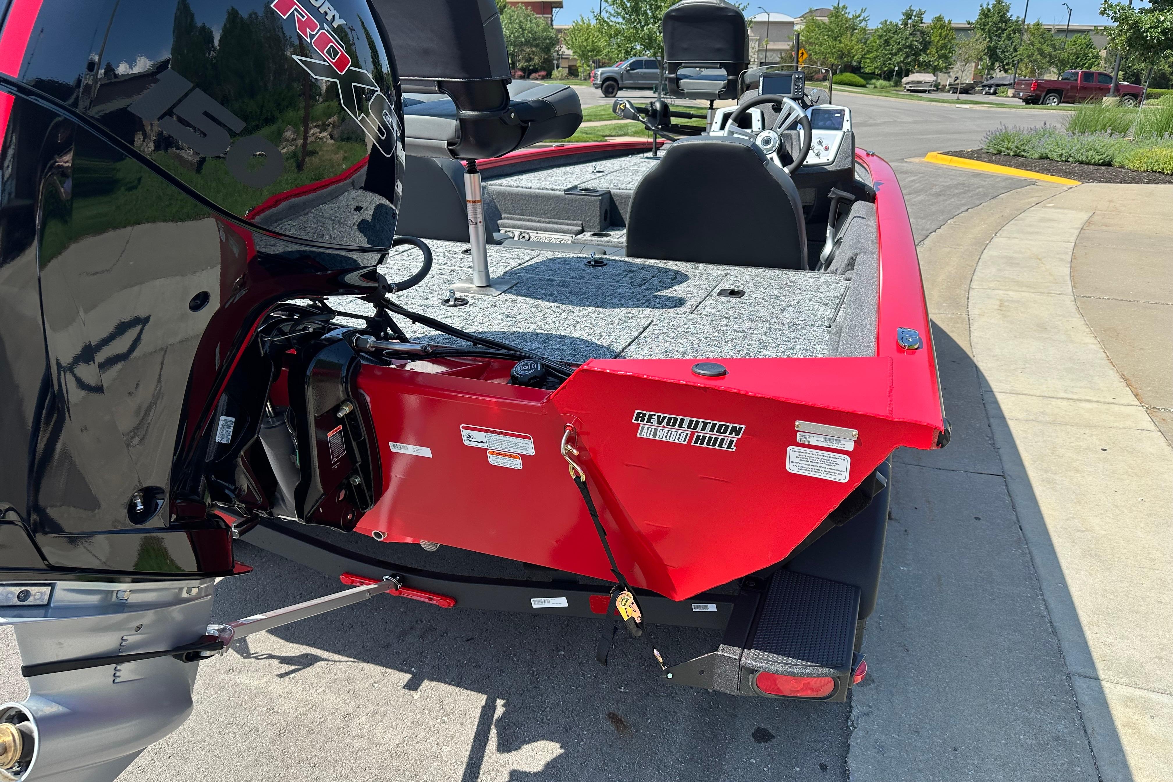 2026 Tracker Pro Team 195 boat with Revolution Hull, parked on a street.