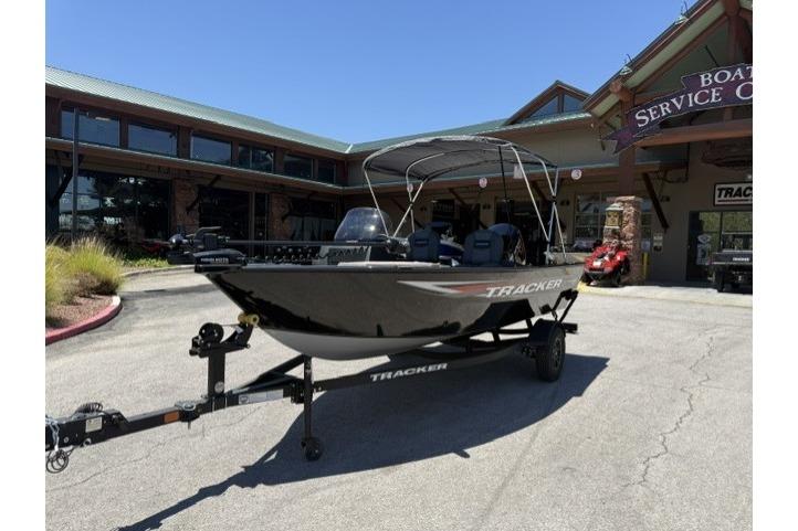 2026 Tracker Pro Guide V-16 SC boat on trailer outside service center.