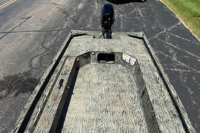 2026 Tracker Grizzly 1654 T Sportsman boat with camouflage design on pavement.