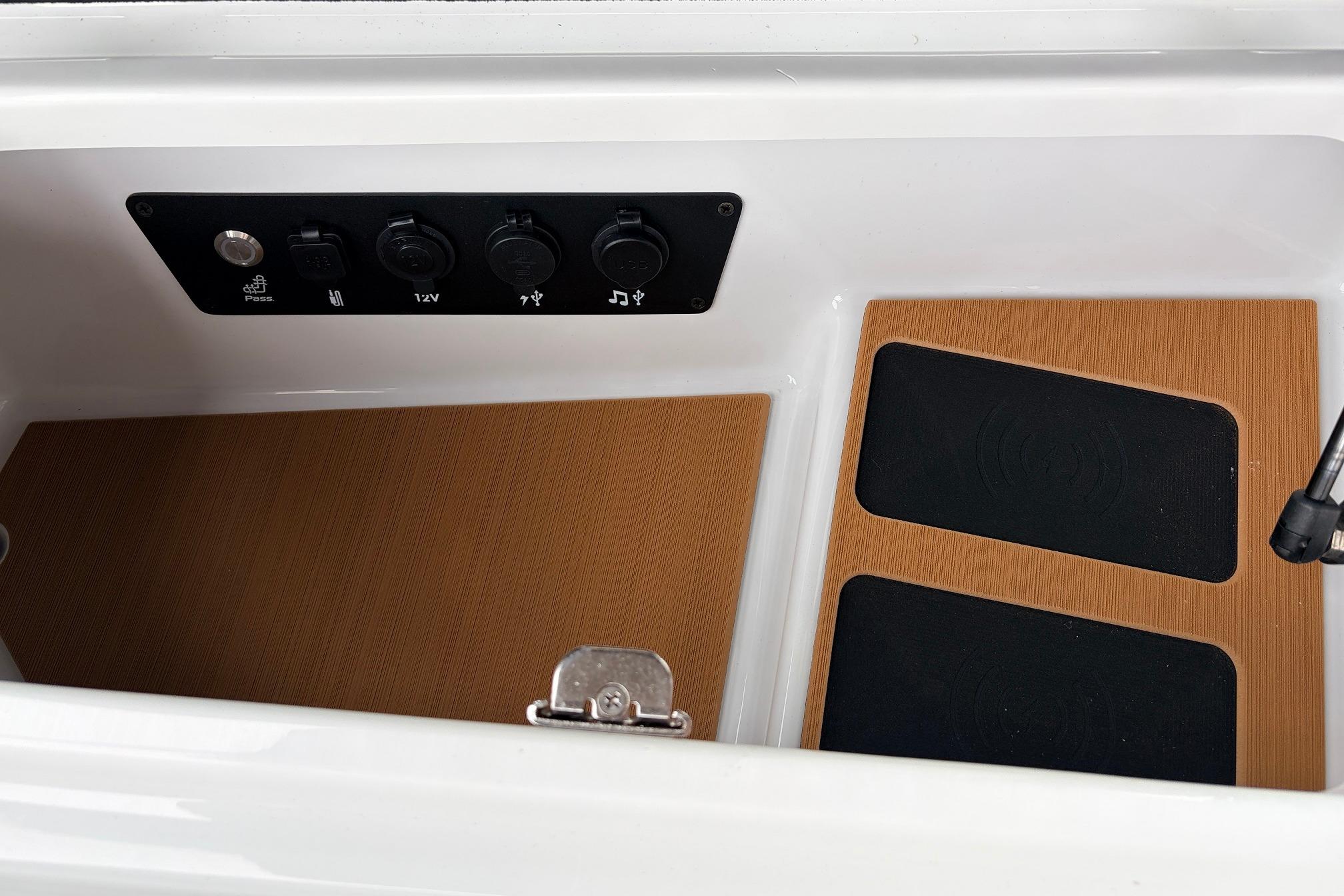 2026 Nautique Super Air Nautique G25 interior compartment with control panel and wooden flooring.