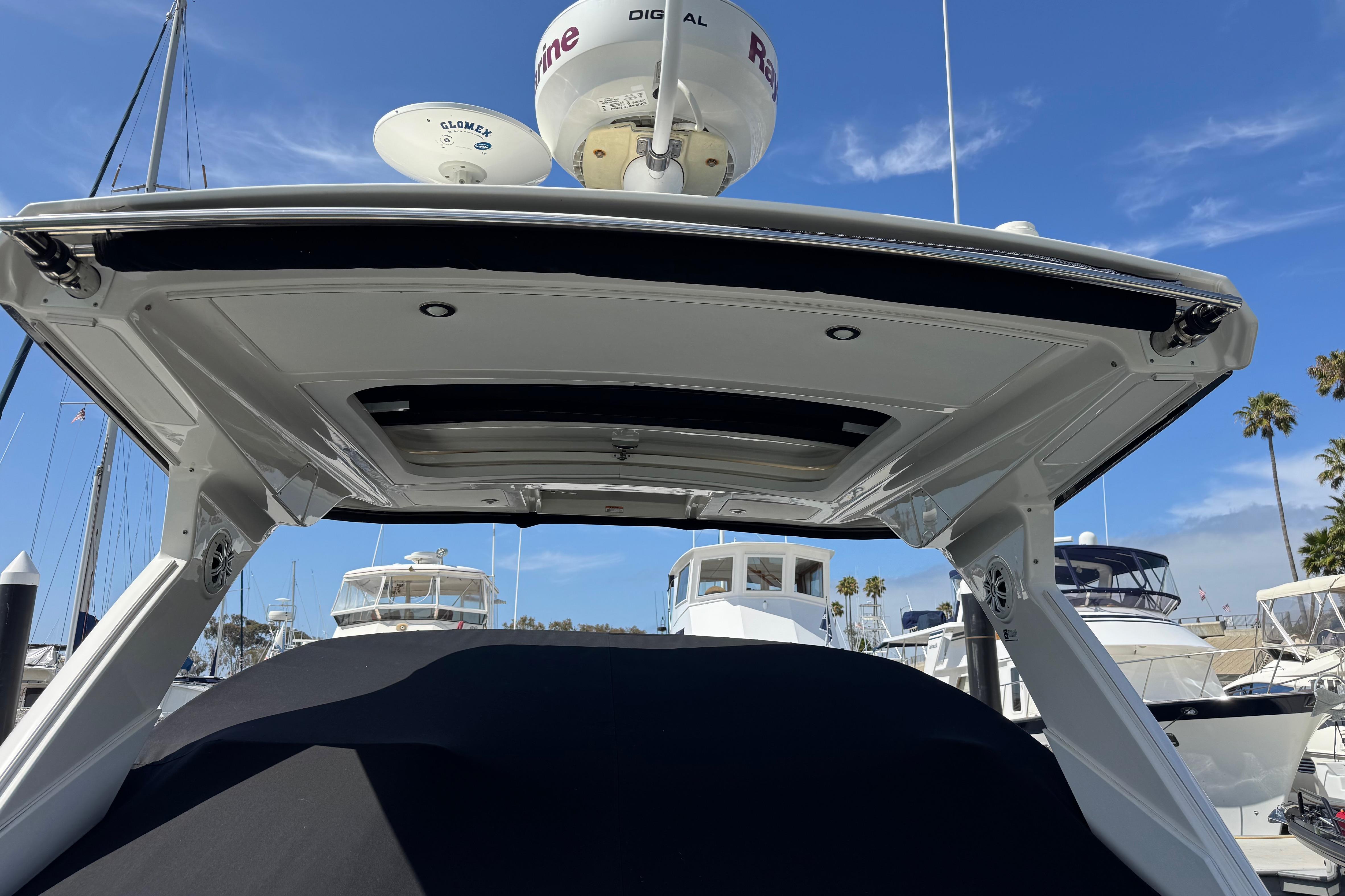 2016 Sea Ray Sundancer 350 yacht at marina, showcasing sleek design and advanced radar equipment.