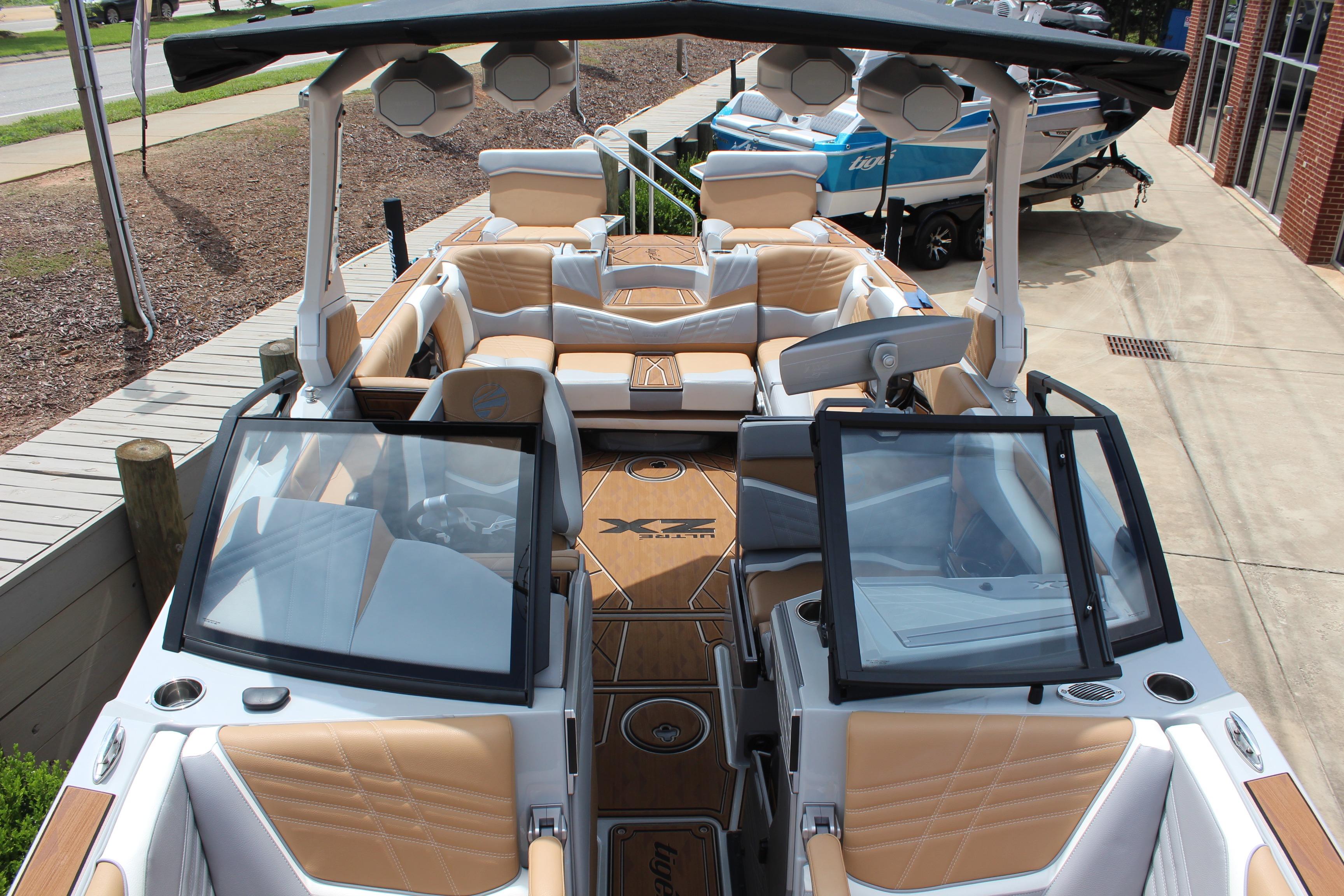 2024 Tigé Ultré 25ZX boat interior with tan and white seating, open windshield, and modern design.