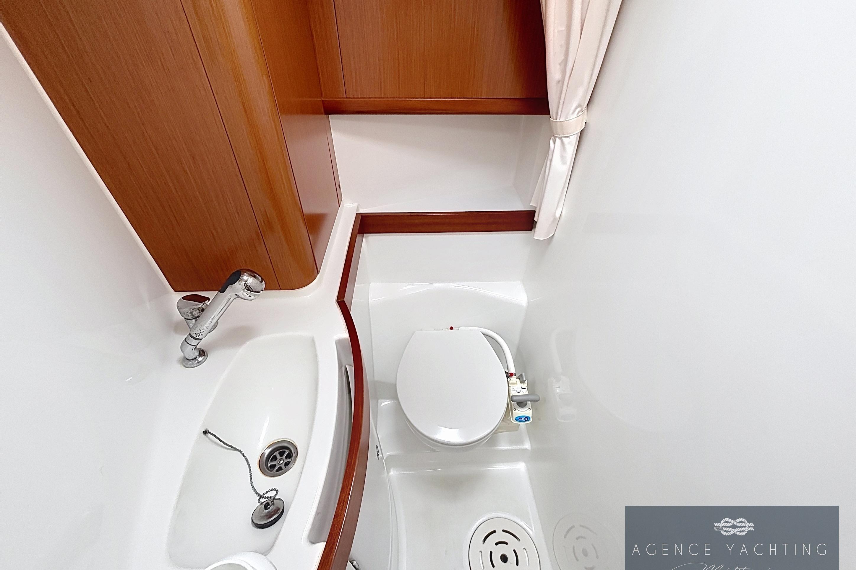 Bathroom interior of 2008 Beneteau Oceanis 40 yacht, featuring sink and toilet.