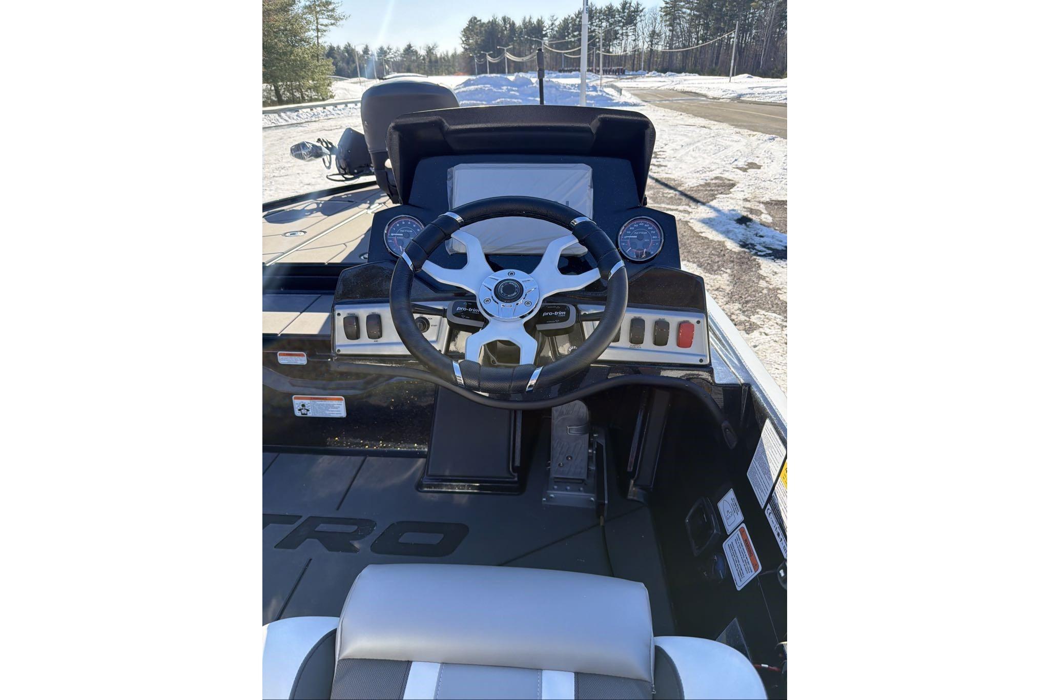 2026 Nitro Z19 XL Pro boat dashboard with steering wheel and gauges in snowy setting.