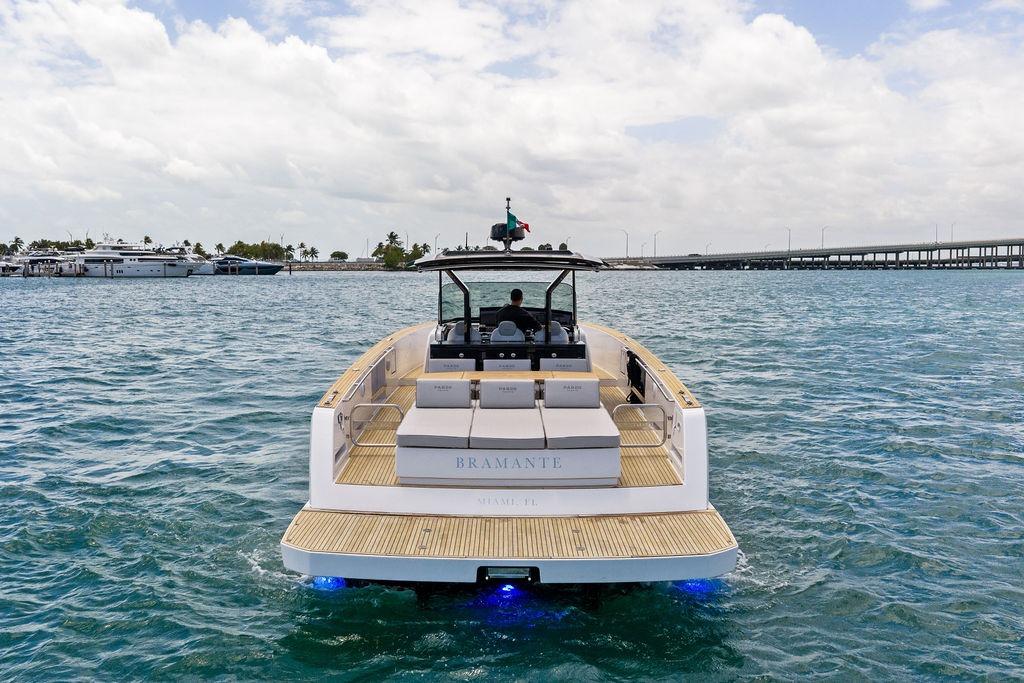 Luxury Pardo 43 yacht cruising on open water, 2021 model, with scenic marina backdrop.