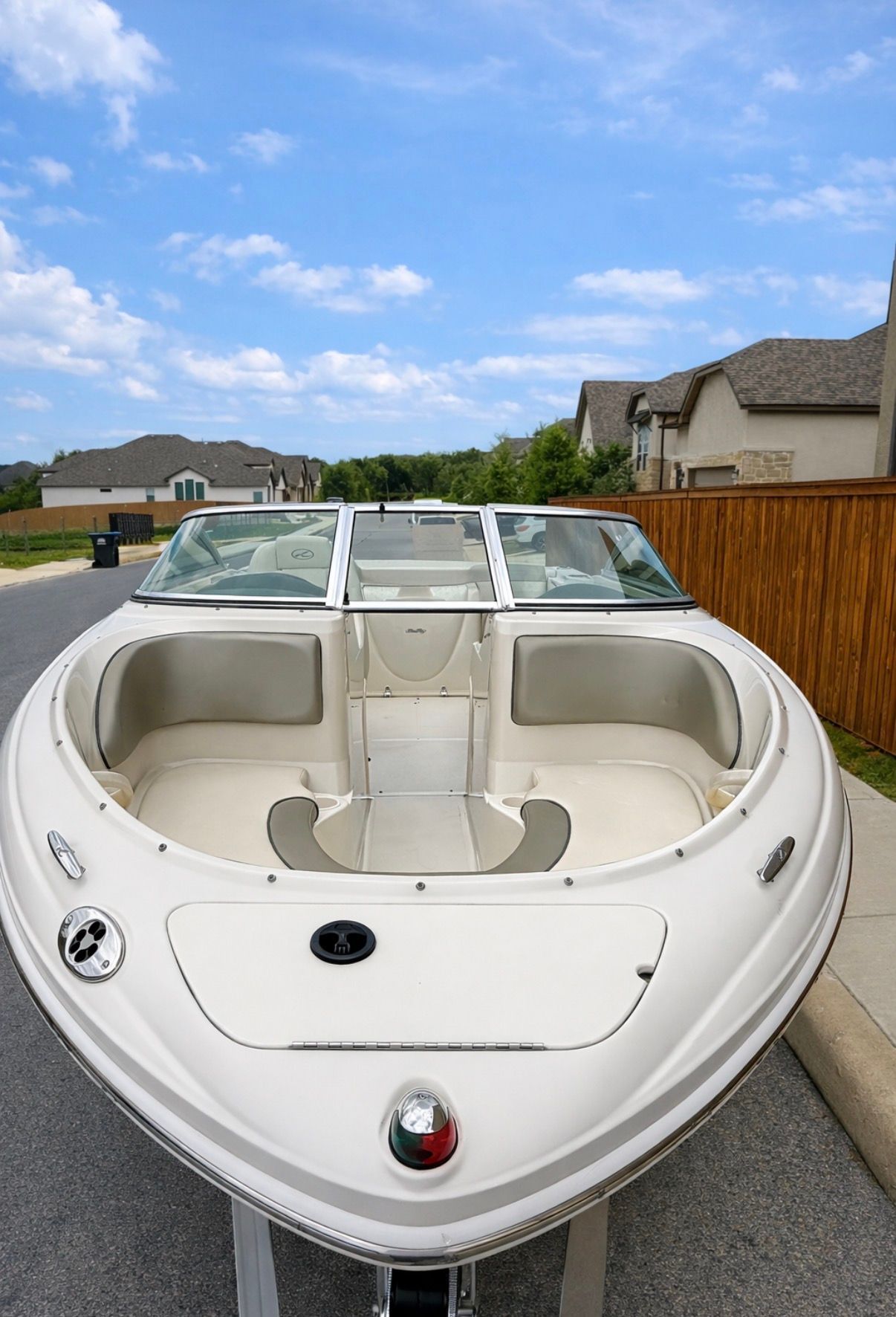 2005 Sea Ray 200 Sport boat parked on a street.