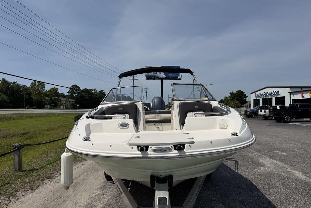 2019 Stingray 201 DS boat on trailer in parking lot, clear sky background.