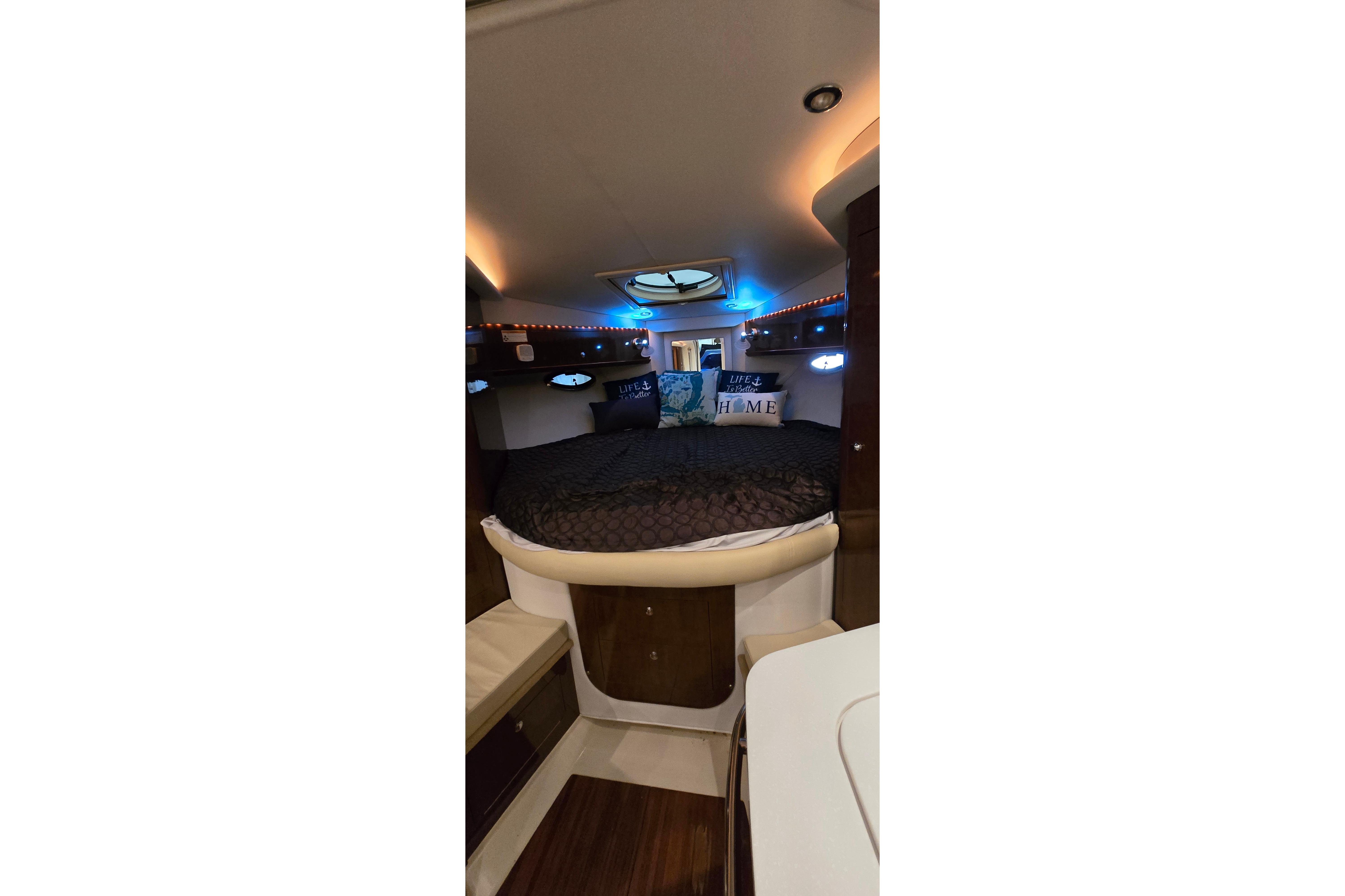 Luxurious interior cabin of 2018 Four Winns V355 boat with cozy bedding.