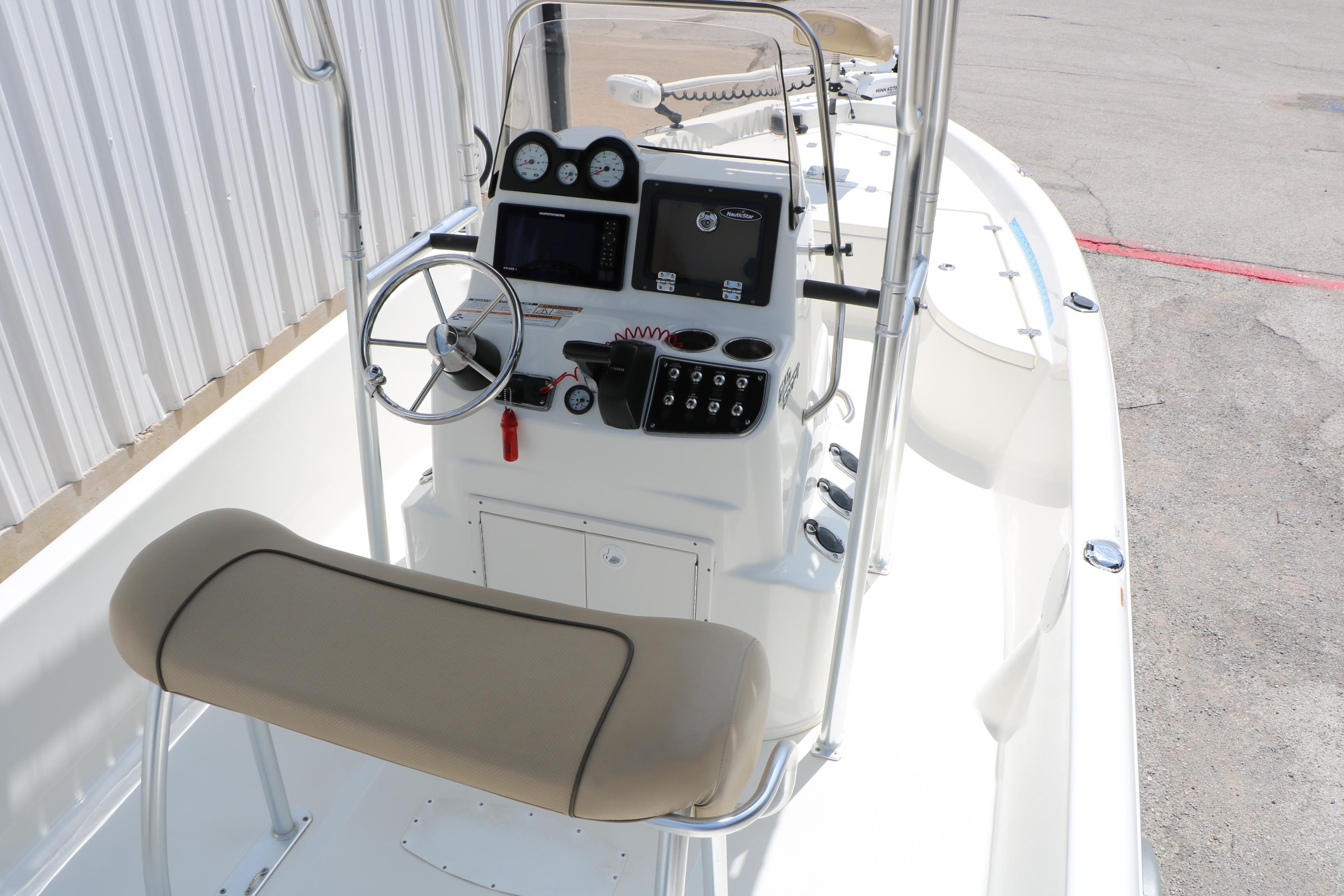2020 NauticStar 2140 Sport boat interior with steering console and seating.