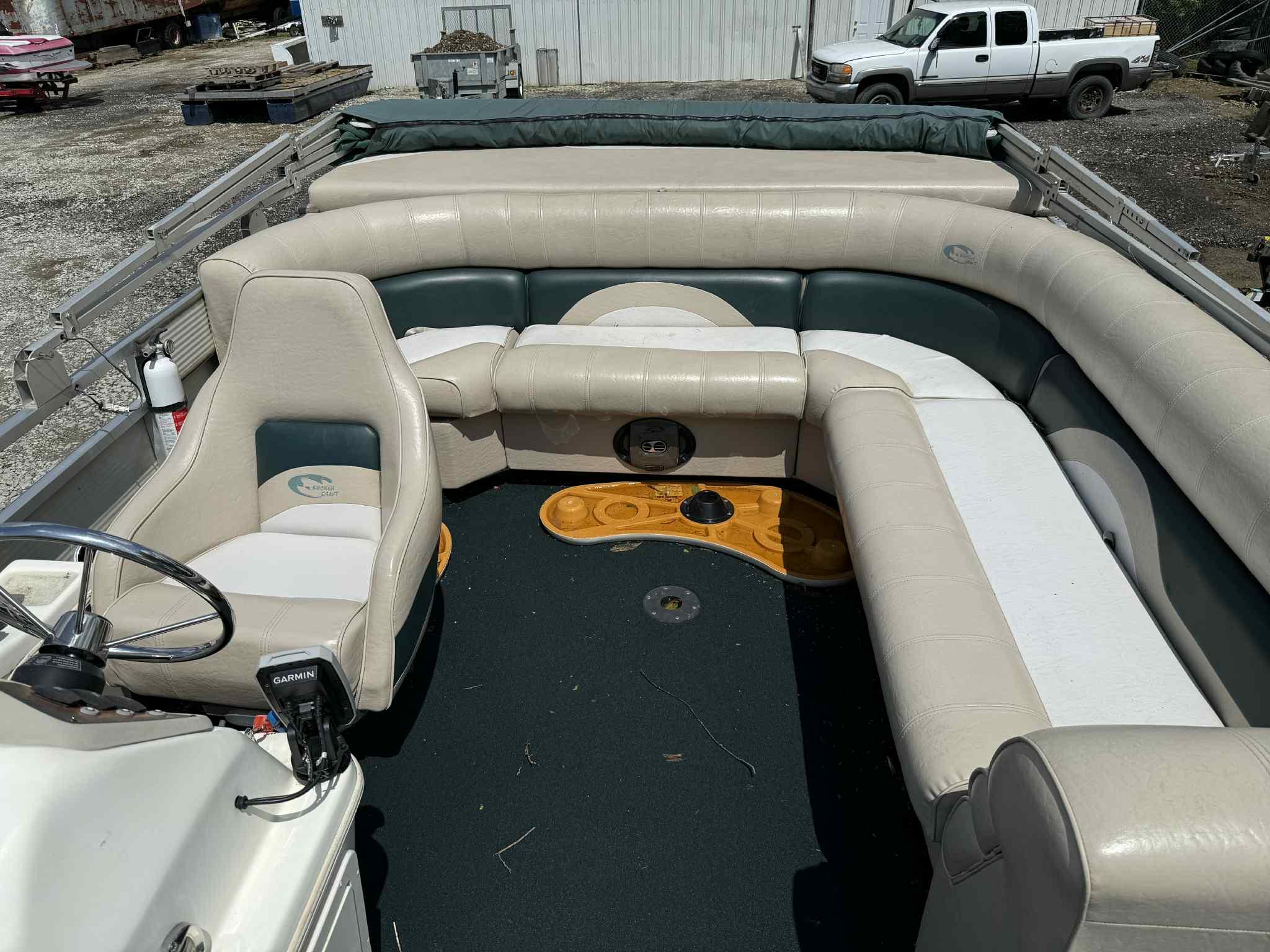1999 Smoker Craft 8526 Pleasure Isle I/O boat interior with beige seating and steering console.