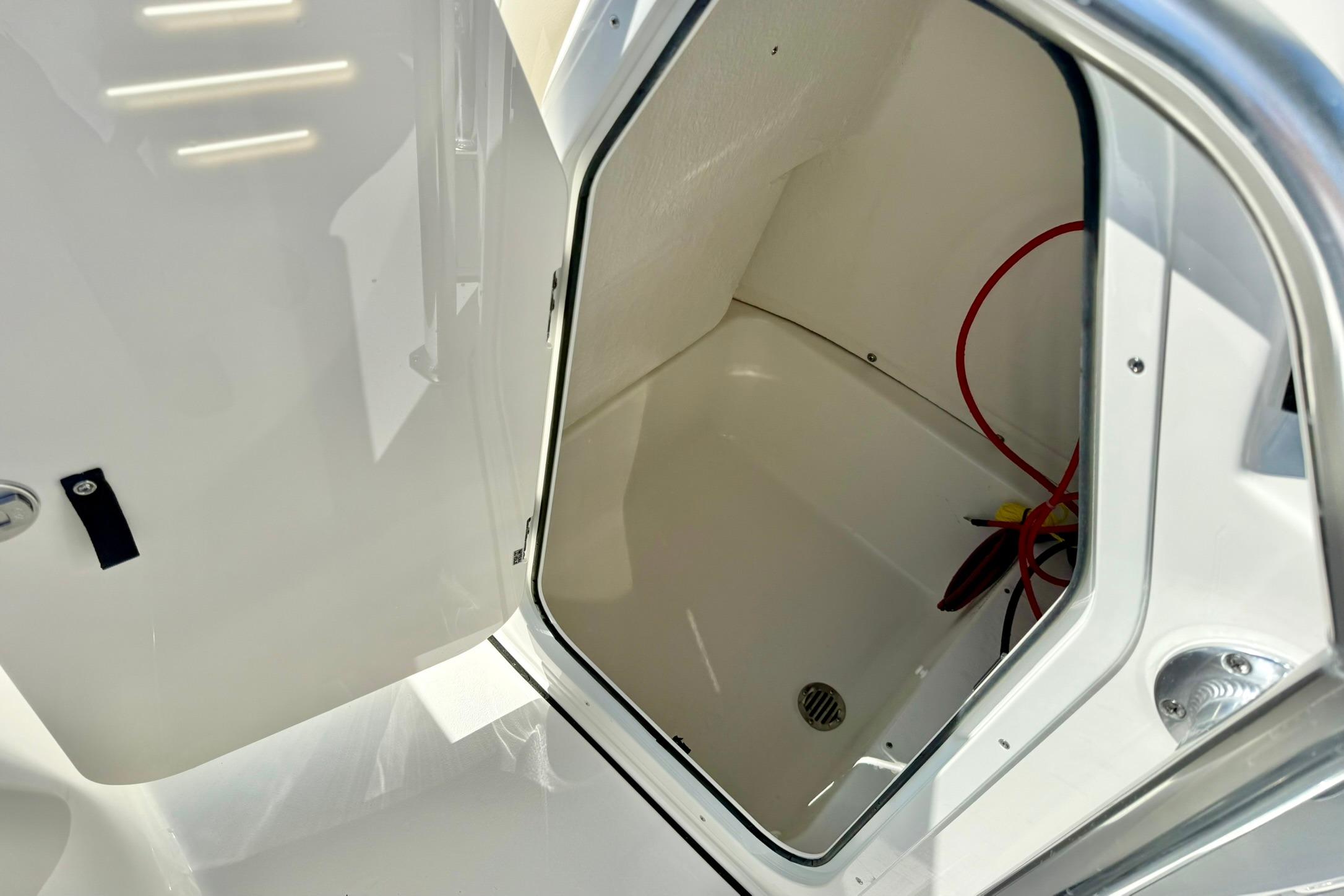 Open storage compartment in 2026 Key West 189 FS boat, featuring clean interior and red wiring.