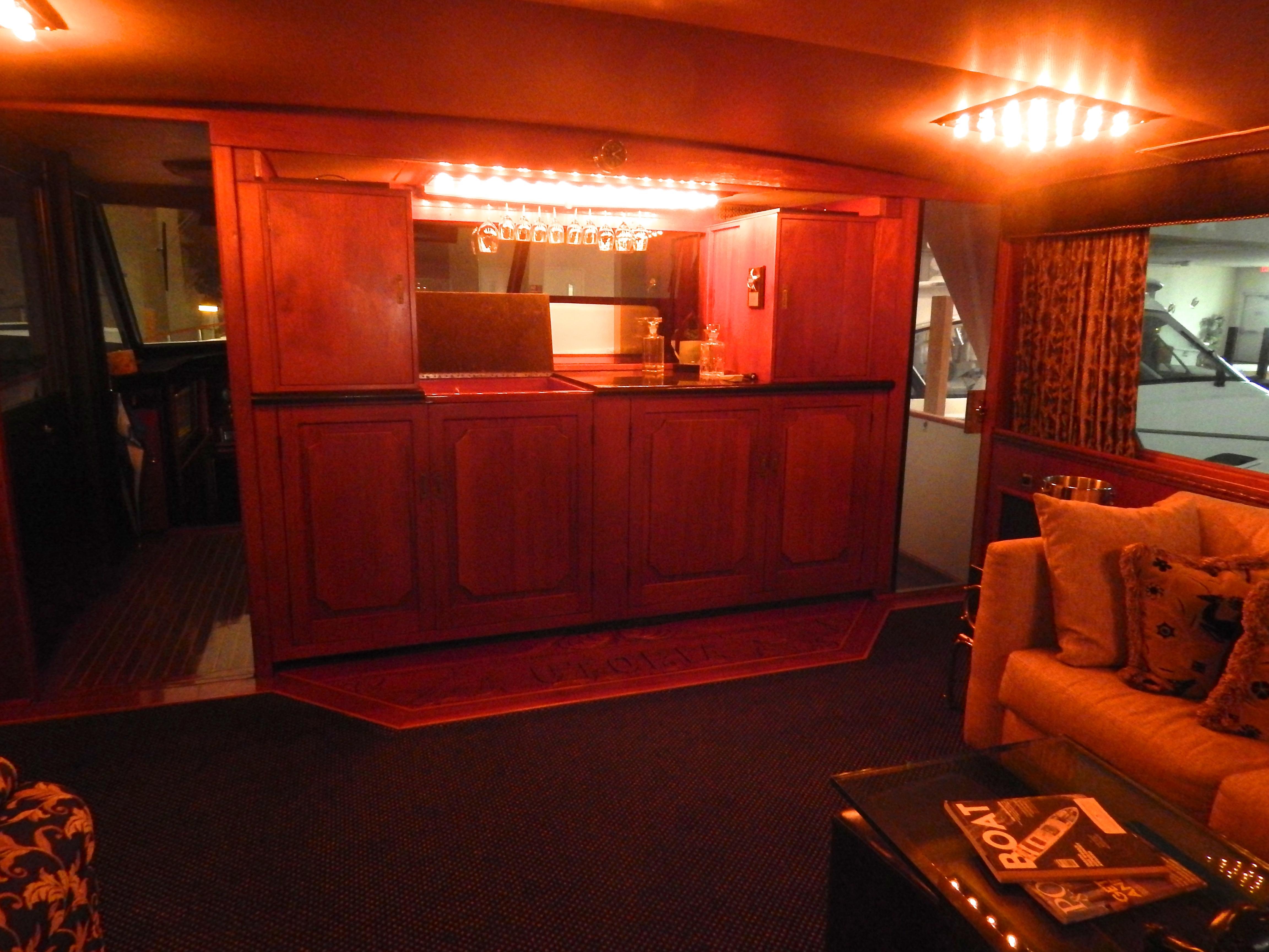 1974 Pacemaker Cockpit Motoryacht interior with elegant wooden bar and cozy seating area.