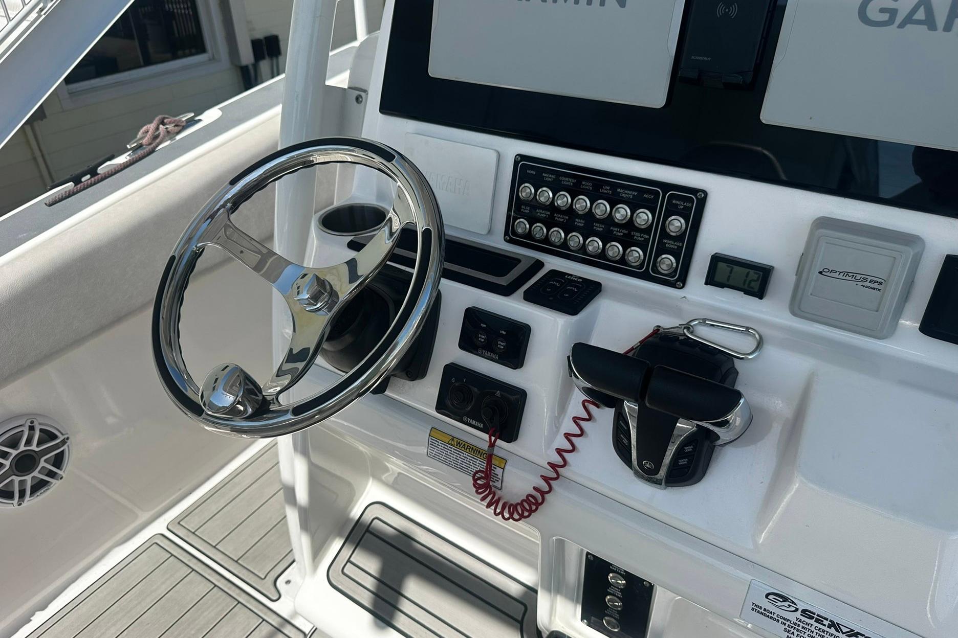 Console of a 2002 Sea Fox 228 Commander boat with steering wheel and controls.
