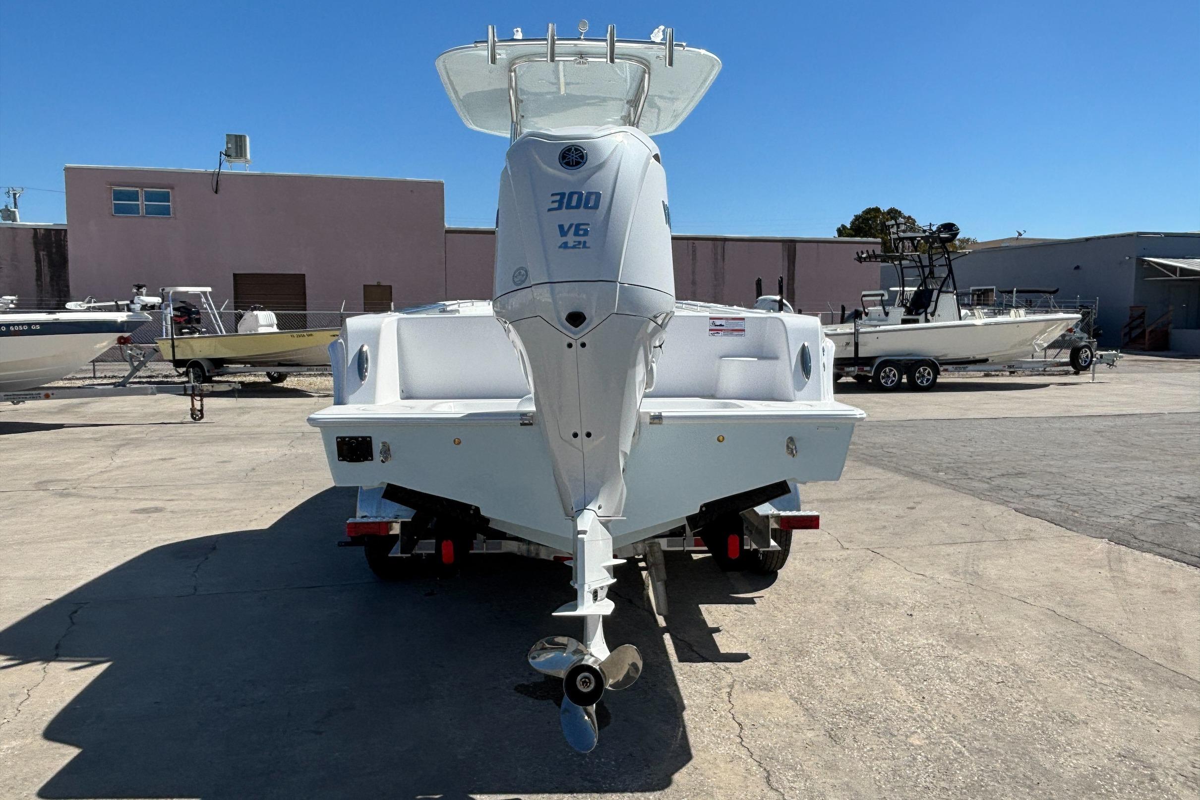 2026 Contender 24 Sport boat with Yamaha 300 V6 engine in a marina setting.