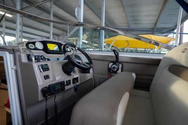 2016 Regal 28 Express boat cockpit with steering wheel and control panel.