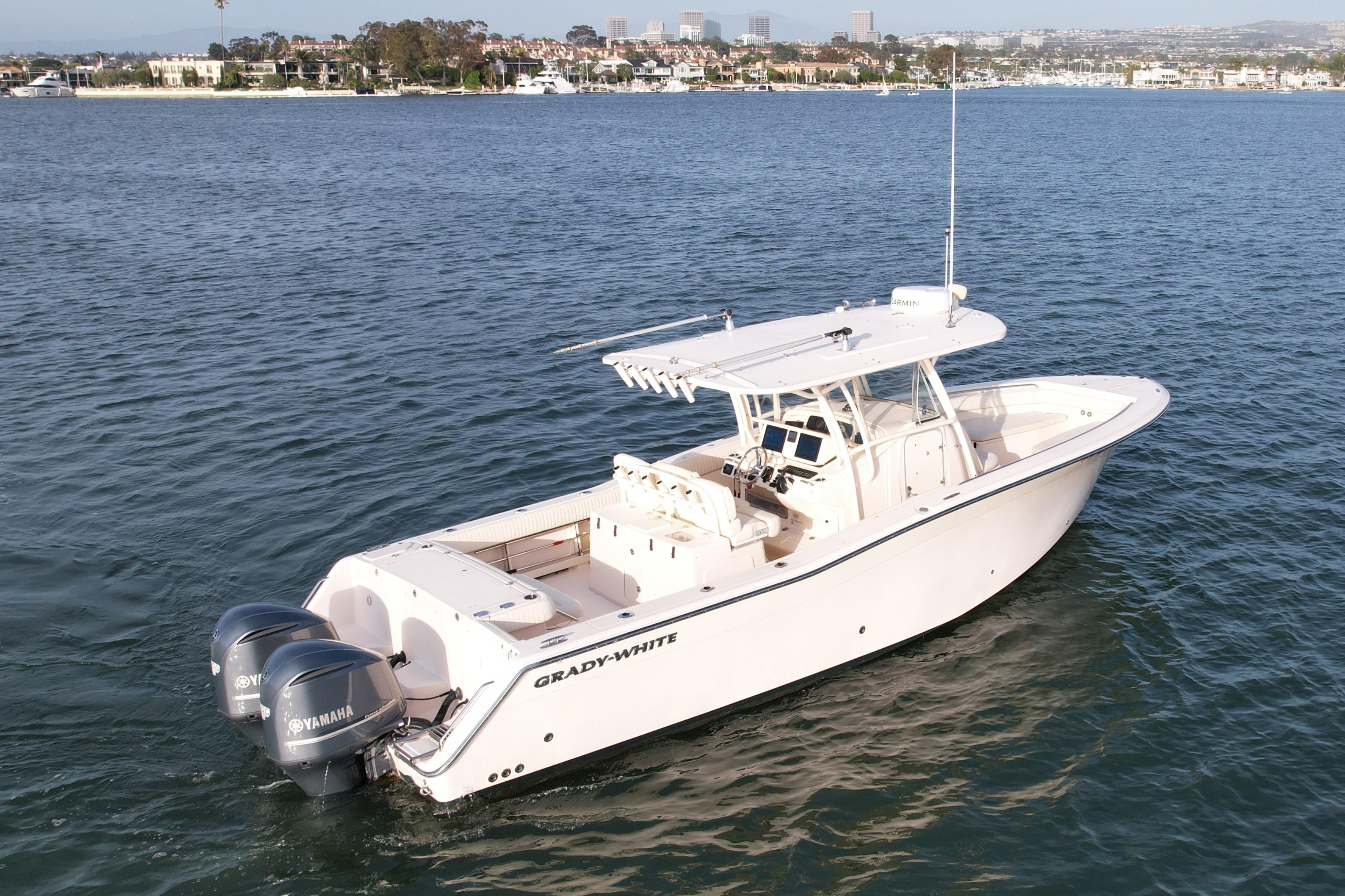 2012 Grady-White Canyon 336 boat on calm water, featuring twin Yamaha engines.