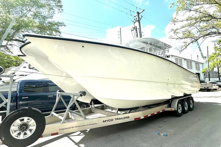 2022 Freeman 34VH boat on Myco trailer, parked outdoors under clear sky.