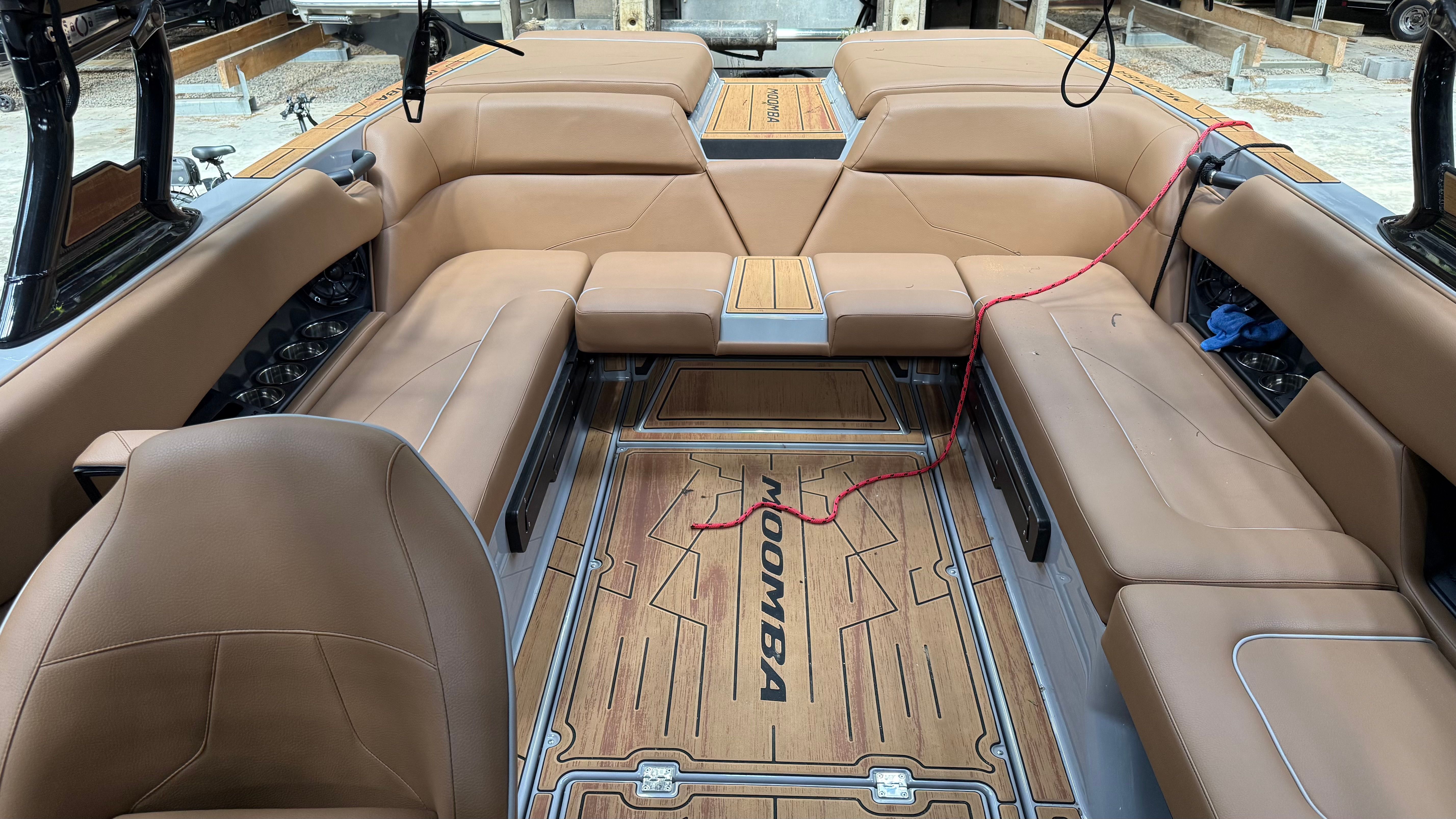 Interior of a 2025 Malibu Mojo with brown leather seating and wood flooring.